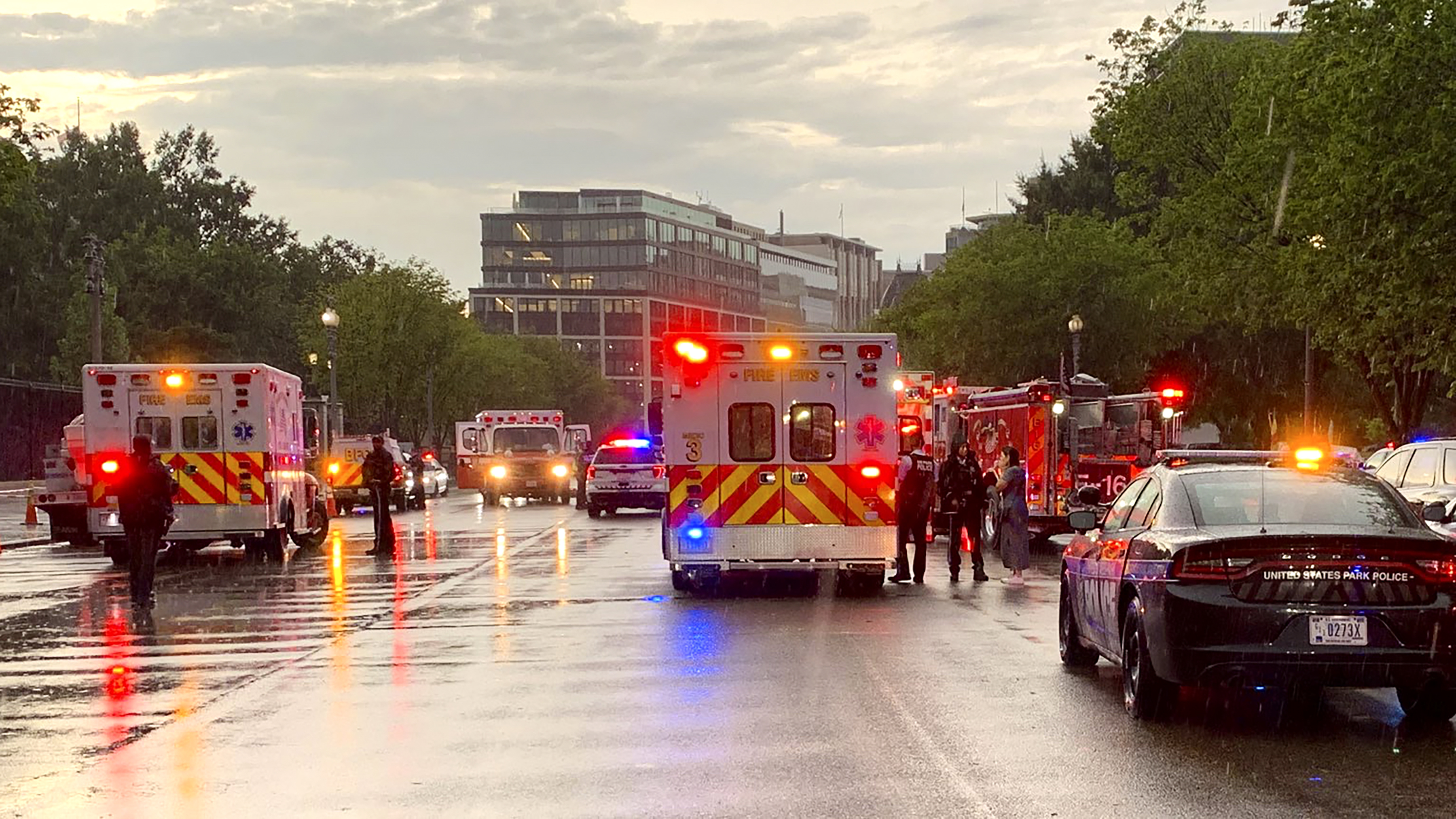 Emergency medical crews are staged on Pennsylvania Avenue between the White House and Lafayette Park, Thursday. Two people who were critically injured in a lightning strike in Lafayette Park outside the White House have died, police said Friday. Two others remained hospitalized with life-threatening injuries.  