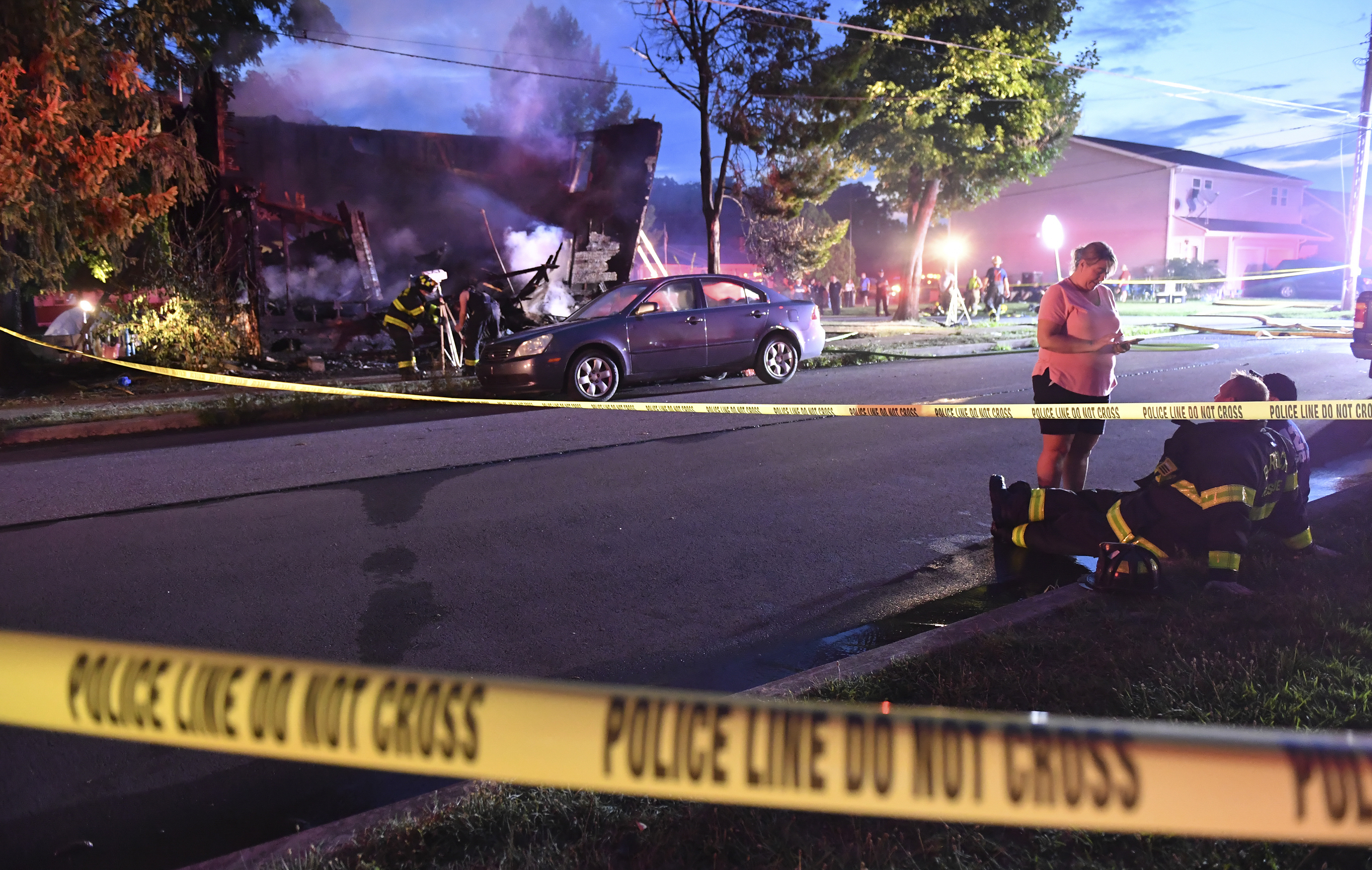 Firefighters set up lights in front of a fatal house fire at 733 First Street in Nescopeck, Pa, Friday. The fire in Nescopeck was reported around 2:30 a.m. EDT. The cause of the fire remains under investigation.