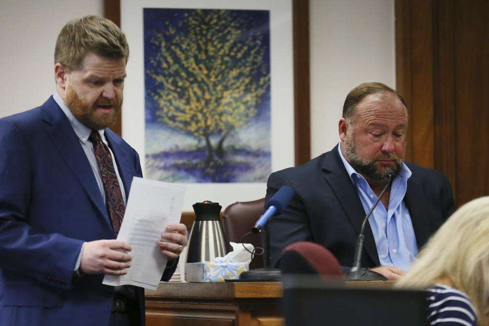 Mark Bankston, lawyer for Neil Heslin and Scarlett Lewis, asks Alex Jones questions about text messages during trial at the Travis County Courthouse in Austin, Wednesday. A Texas jury on Friday ordered Infowars’ Alex Jones to pay $49.3 million in total damages to the parents of a first-grader killed in the 2012 Sandy Hook Elementary School massacre.