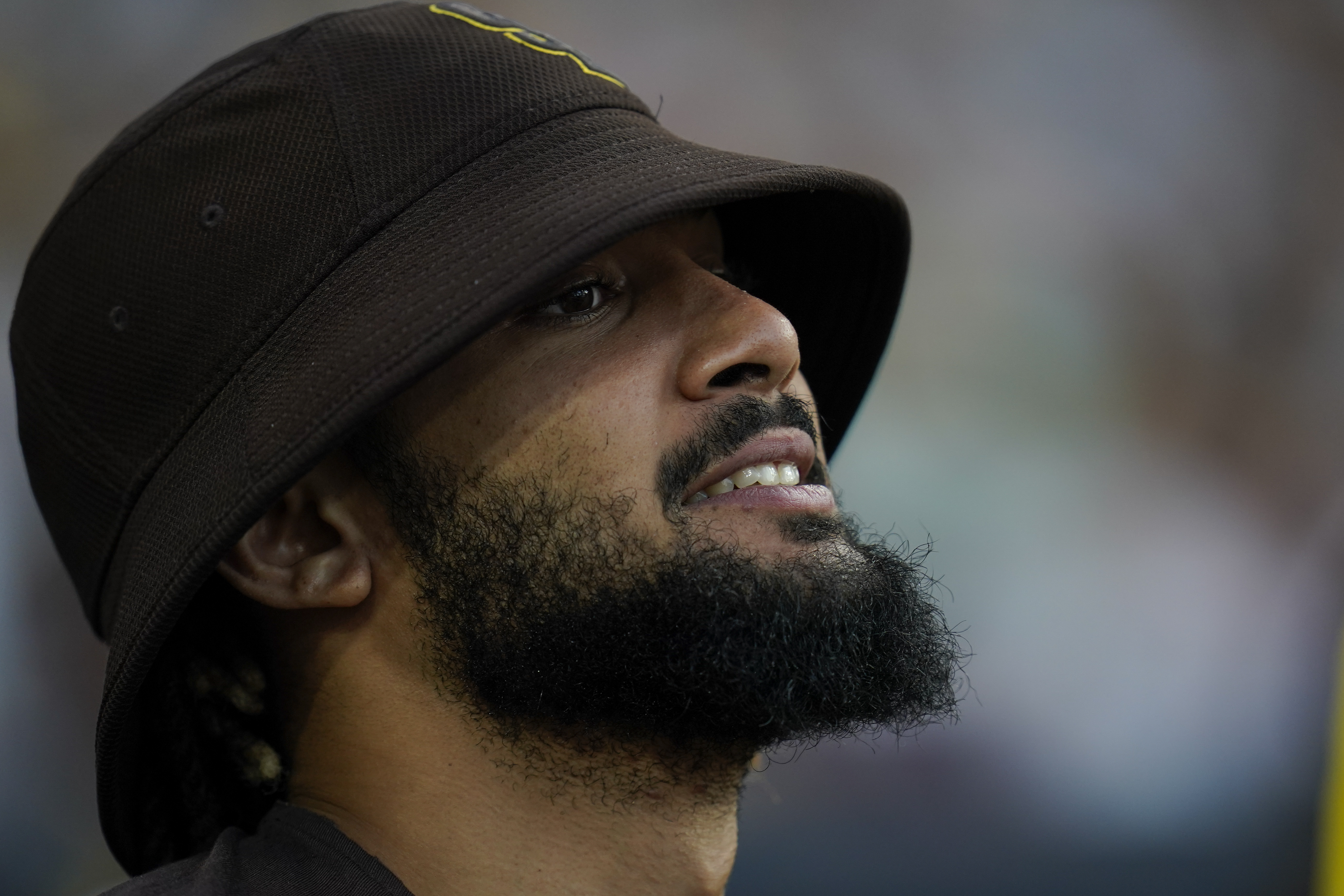The San Diego Padres' Fernando Tatis Jr reacts in the dugout before the first inning of a baseball game against the Colorado Rockies, Monday, Aug. 1, 2022, in San Diego. 