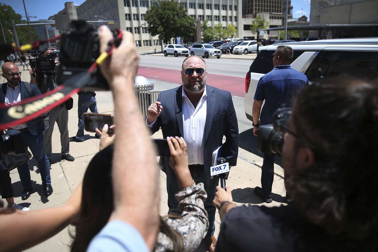 Alex Jones arrives at the Travis County Courthouse in Austin, Texas, on Tuesday. The father of a 6-year-old killed in the Sandy Hook Elementary School shooting has testified that conspiracy theorist Alex Jones made his life a “living hell” by pushing claims the murders were a hoax. Neil Heslin testified Tuesday that he fears for his life because of Jones' claims. Heslin and Scarlett Lewis are the parents of 6-year-old Jesse Lewis.