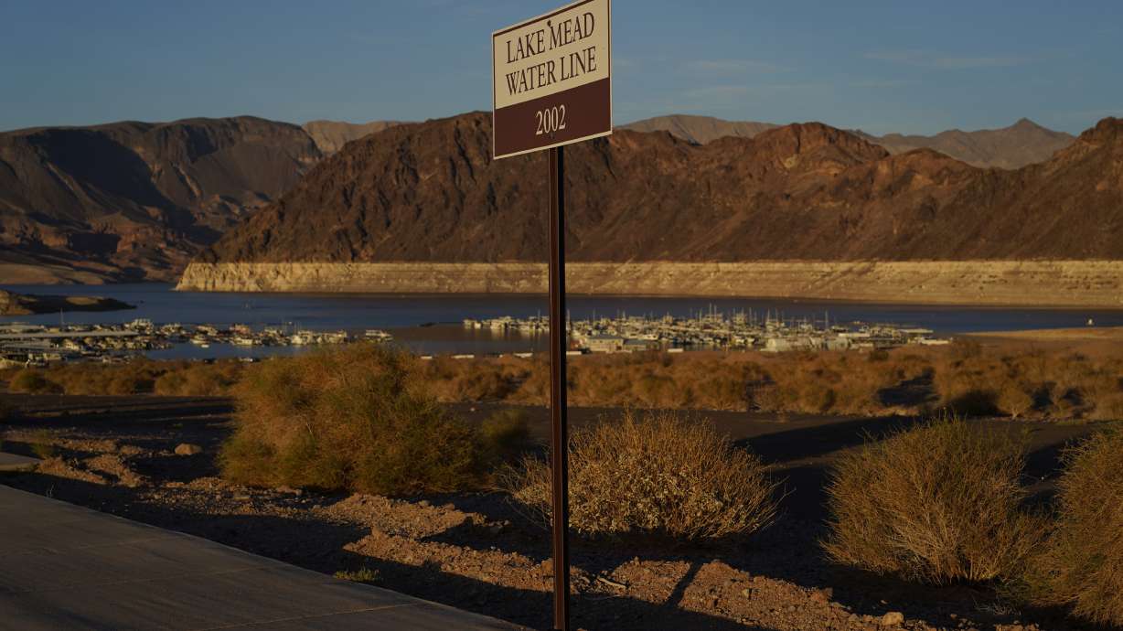 A sign marks the water line from 2002 near Lake Mead at the Lake Mead National Recreation Area on July 9, 2022 near Boulder City, Nevada. The largest U.S. reservoir has shrunken to a record low amid a punishing drought and the demands of 40 million people in seven states who are sucking the Colorado River dry.