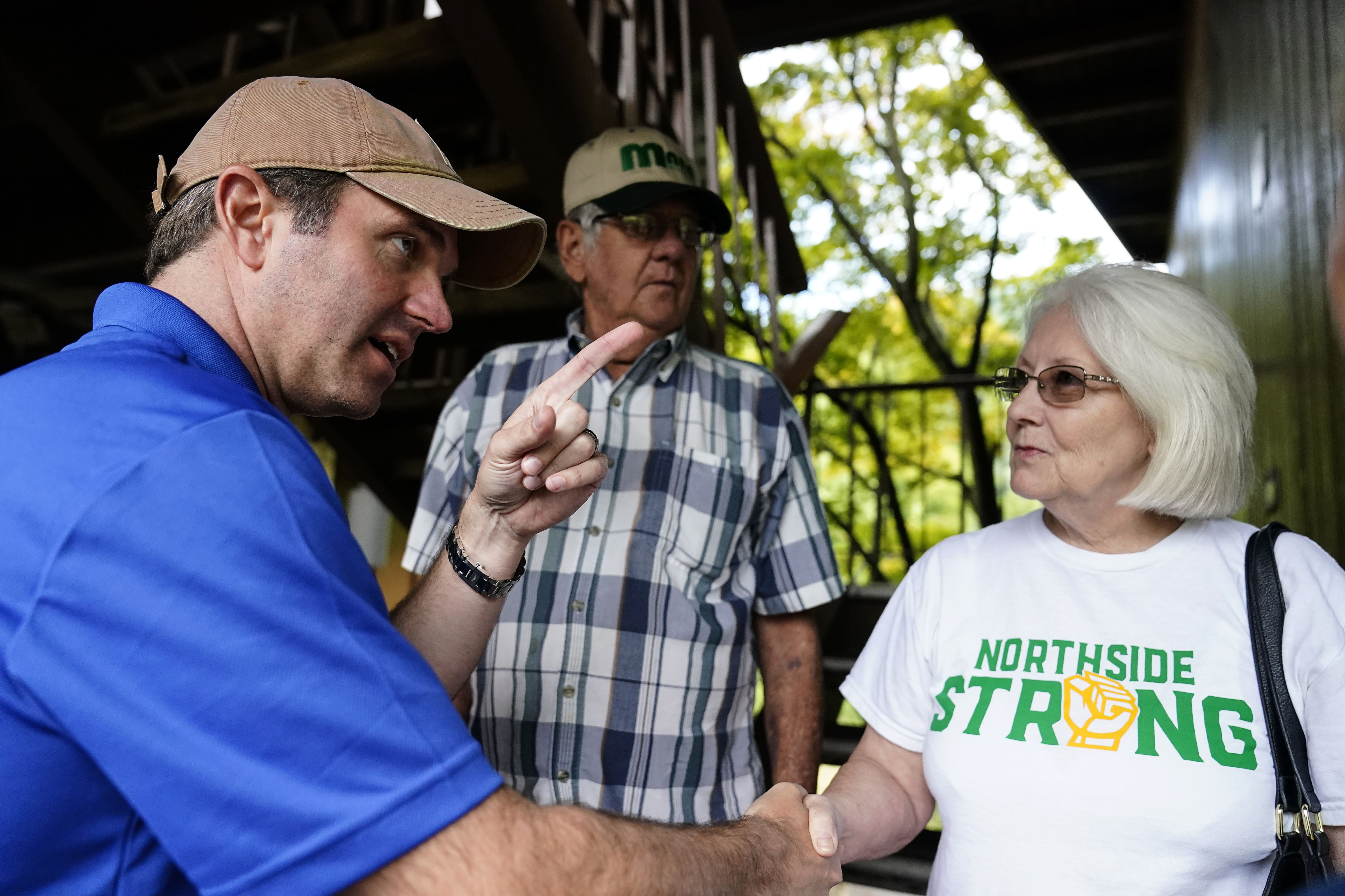 Kentucky Governor Andy Beshear, center, talks with residents that have been displaced by floodwaters at Jenny Wiley State Resort Park Saturday, in Prestonsburg, Kentucky.