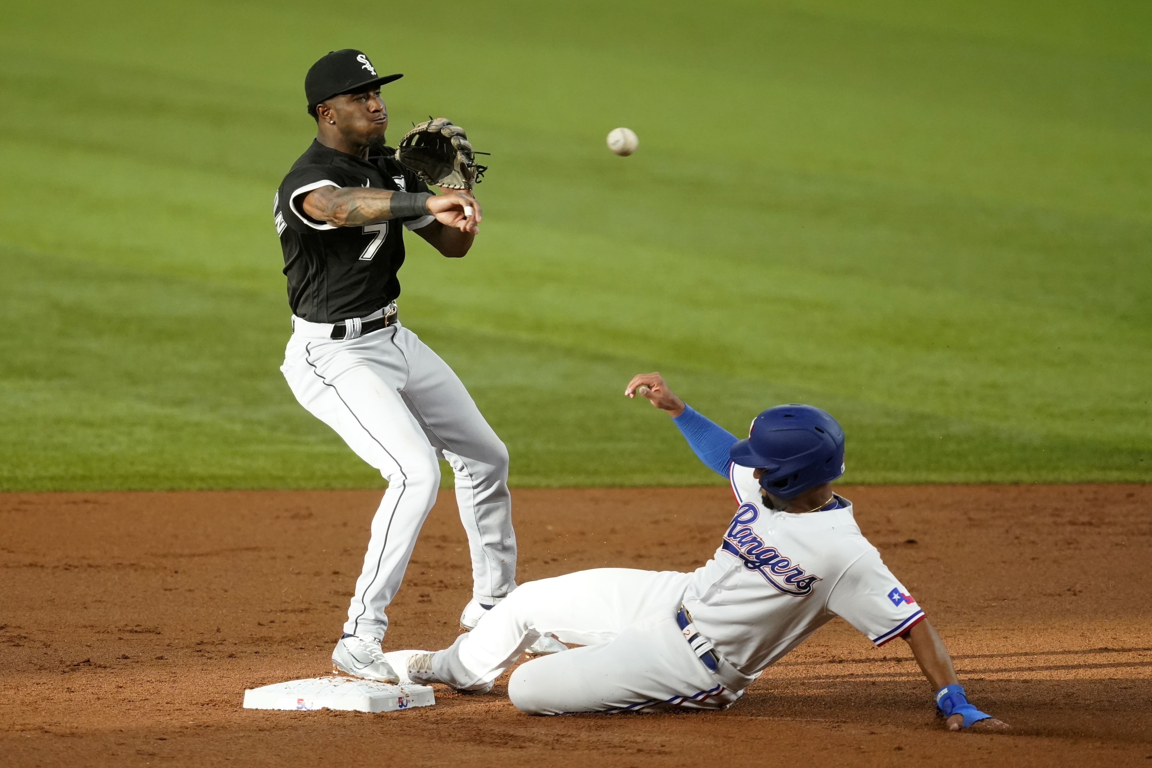 Chicago White Sox shortstop Tim Anderson throw to first to complete the double play after forcing Texas Rangers' Marcus Semien at second in the first inning of a baseball game, Thursday, Aug. 4, 2022, in Arlington, Texas. Corey Seager was out at first. 