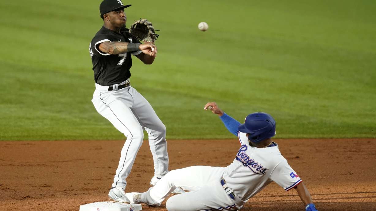 Chicago White Sox shortstop Tim Anderson throw to first to complete the double play after forcing Texas Rangers' Marcus Semien at second in the first inning of a baseball game, Thursday, Aug. 4, 2022, in Arlington, Texas. Corey Seager was out at first.