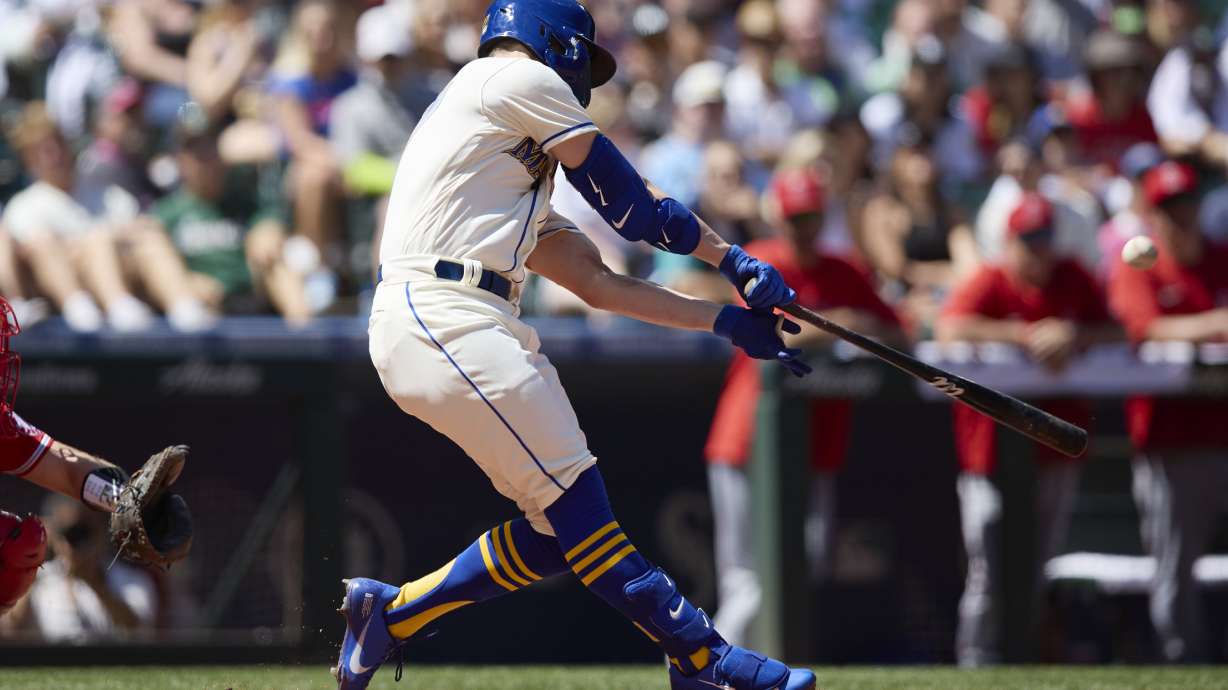 Seattle Mariners' Jesse Winker hits a grand slam against the Los Angeles Angels on a pitch from Tucker Davidson during third inning of a baseball game, Sunday, Aug. 7, 2022, in Seattle.