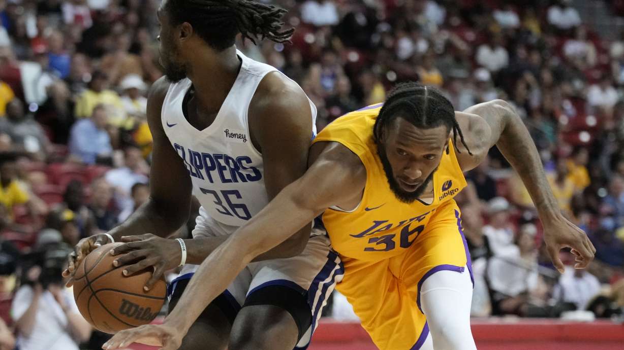 Los Angeles Lakers' Paris Bass, right, attempt to steal the ball from Los Angeles Clippers' Jarrell Brantley during the first half an NBA summer league basketball game Tuesday, July 12, 2022, in Las Vegas.