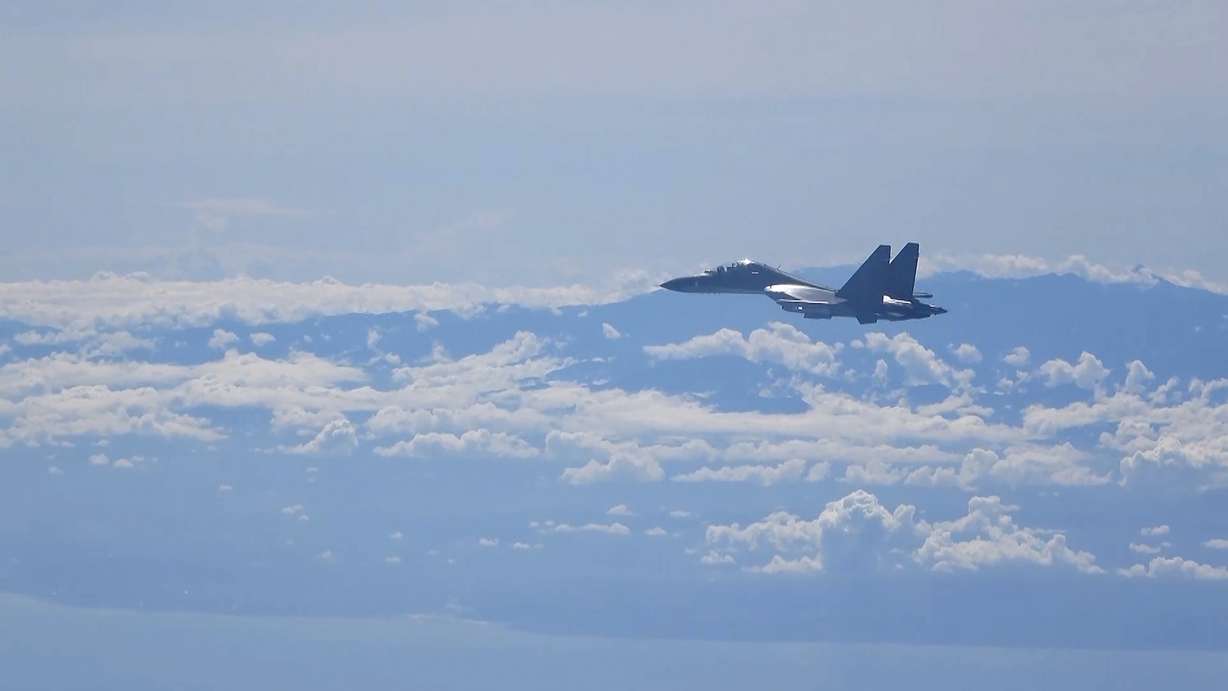 In this image made from video and released by China's Xinhua News Agency, a Chinese military plane flies during a training exercise of the air force corps of the Eastern Theater Command of the Chinese People's Liberation Army, Friday.