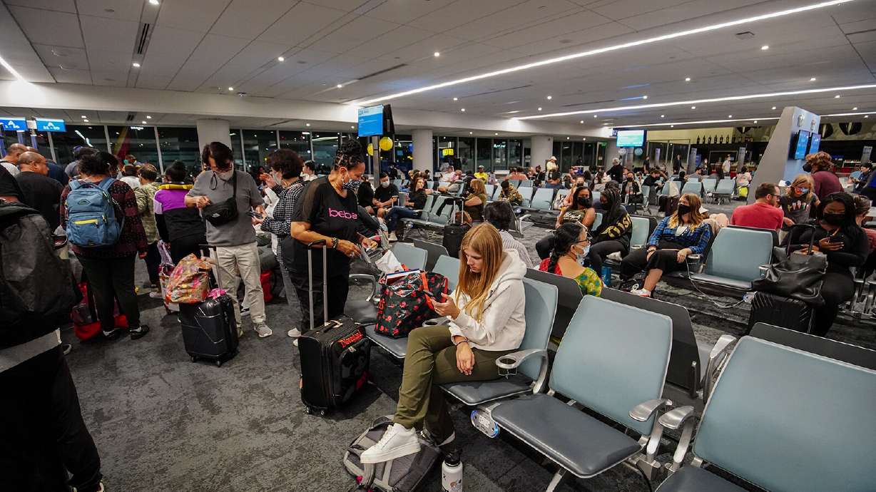 Travelers wait for their flight at Los Angeles International Airport. According to the flight tracking website, FlightAware, there have been 290 flights canceled so far on Monday. On Sunday, 950 flights were canceled.