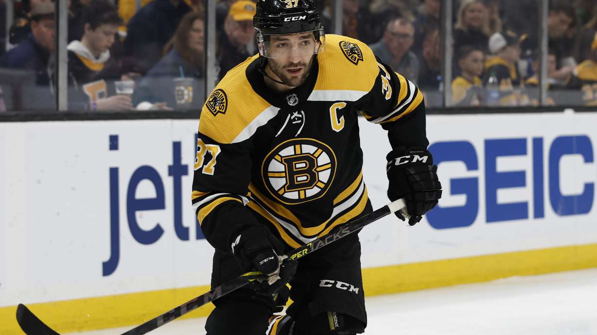 FILE - Boston Bruins' Patrice Bergeron is shown during the first period of an NHL hockey game against the Pittsburgh Penguins, Saturday, April 16, 2022, in Boston. Bruins captain Patrice Bergeron is coming back for another season. Almost three months after he left the ice without any certainty that he would return, the five-time Selke Trophy winner signed a one-year deal with the Bruins on Monday, Aug. 8, 2022.