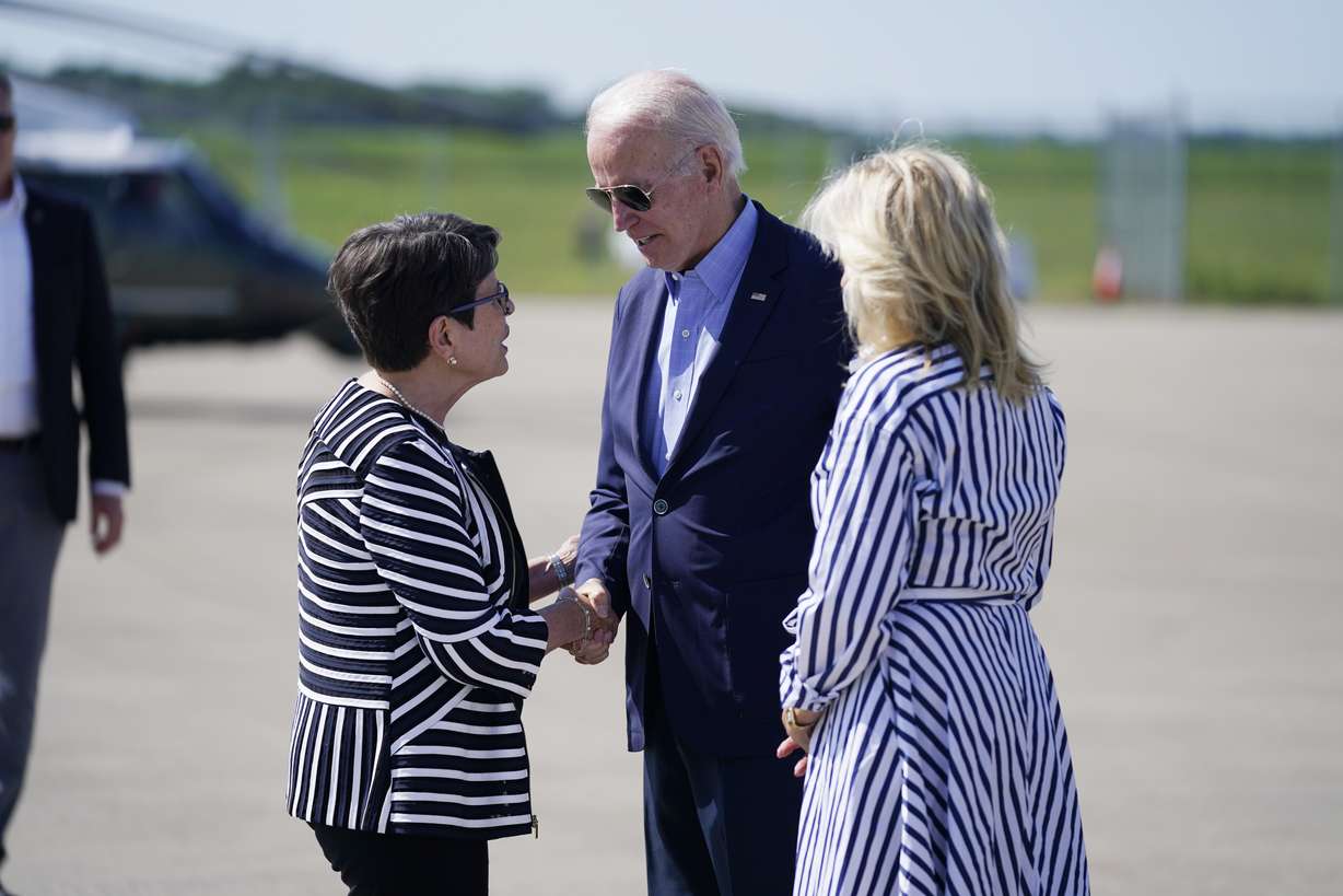 President Joe Biden and first lady Jill Biden are greeted by Lexington Mayor Linda Gorton, as they arrive at Blue Grass Airport for a visit to view flood damage, Monday in Lexington, Ky.