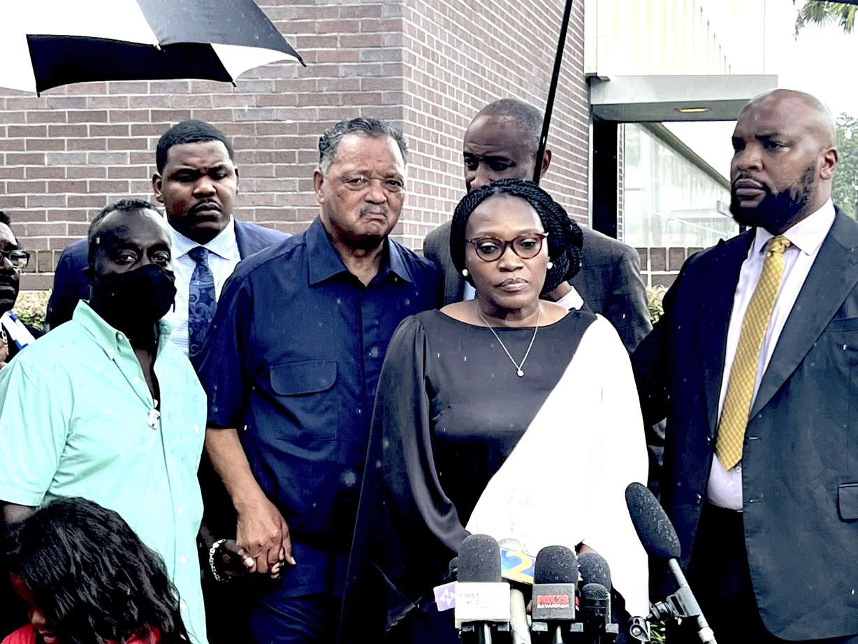 Wanda Cooper-Jones and Marcus Arbery, the parents of Ahmaud Arbery, are flanked by Rev. Jesse Jackson and Attorney Lee Merritt while addressing the media following the sentencing of Travis McMicheal in federal court in Brunswick, Ga. on Monday.