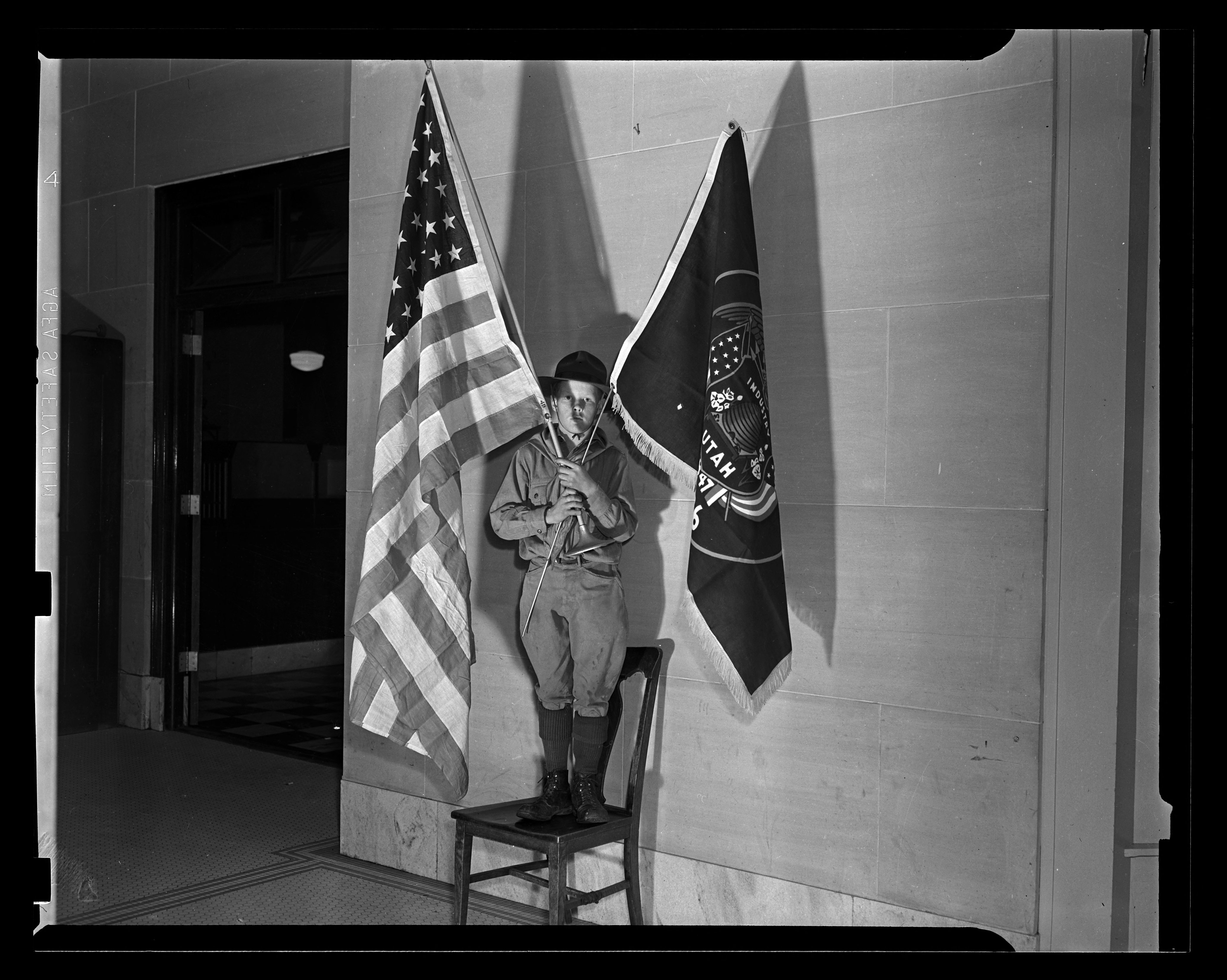 Boy Scout with United States and Utah flags, 1940. © The Salt Lake Tribune, from the Utah Division of State History’s digital collection.