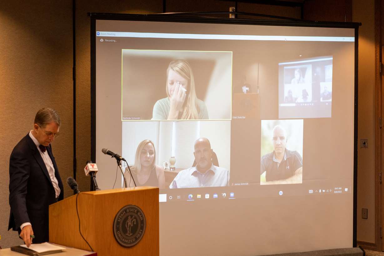 Jim McConkie of Parker & McConkie, stands at the podium while Gabby Petito mother, Nichole Schmidt, wipes tears with a tissue during a press conference at the Utah Law & Justice Center in Salt Lake City on Monday.