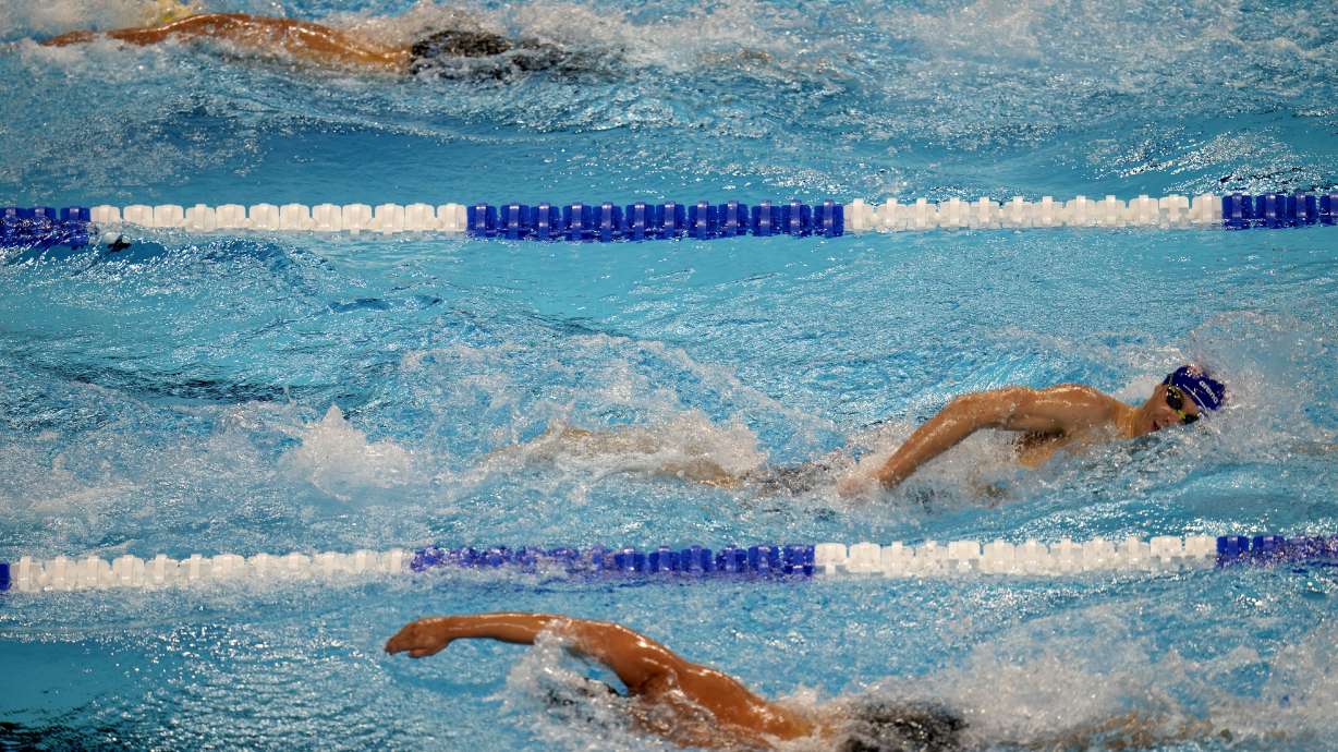 FILE - Swimmers compete during the U.S. Olympic Swim Trials in Omaha, Neb., on June 20, 2021. USA Swimming has added technology to its abuse-reporting systems that will allow better communication between investigators and reporters who want to remain anonymous. On Monday, Aug. 8, 2022, the organization announced a deal with RealResponse, which is international Safe Sport Day.