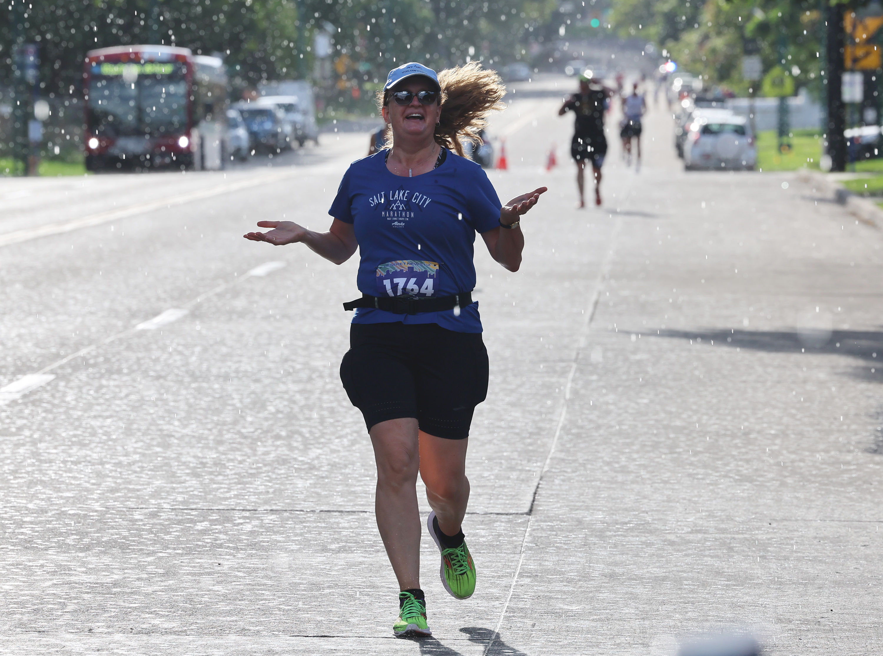 Wendy Wadsworth holds out her hands as rain falls during a portion of in the Deseret News Marathon in Salt Lake City on July 23. Last month was the sixth-hottest, but 59th-wettest July in all of Utah since statewide records were first kept in 1895. 