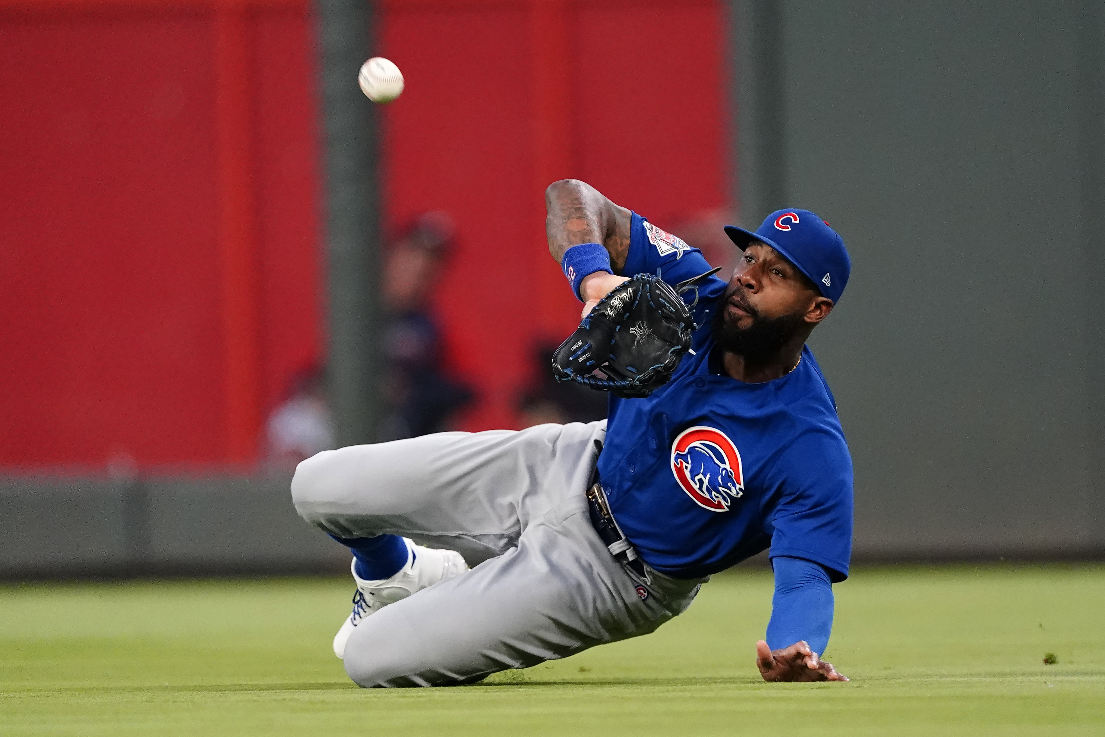 FILE - Chicago Cubs right fielder Jason Heyward makes a diving catch on a fly ball by Atlanta Braves' Austin Riley in the third inning of a baseball game April 28, 2021, in Atlanta. The Cubs will cut ties with Heyward after this season, ending one of baseball’s most expensive and unproductive free-agent signings with a year left on his contract.