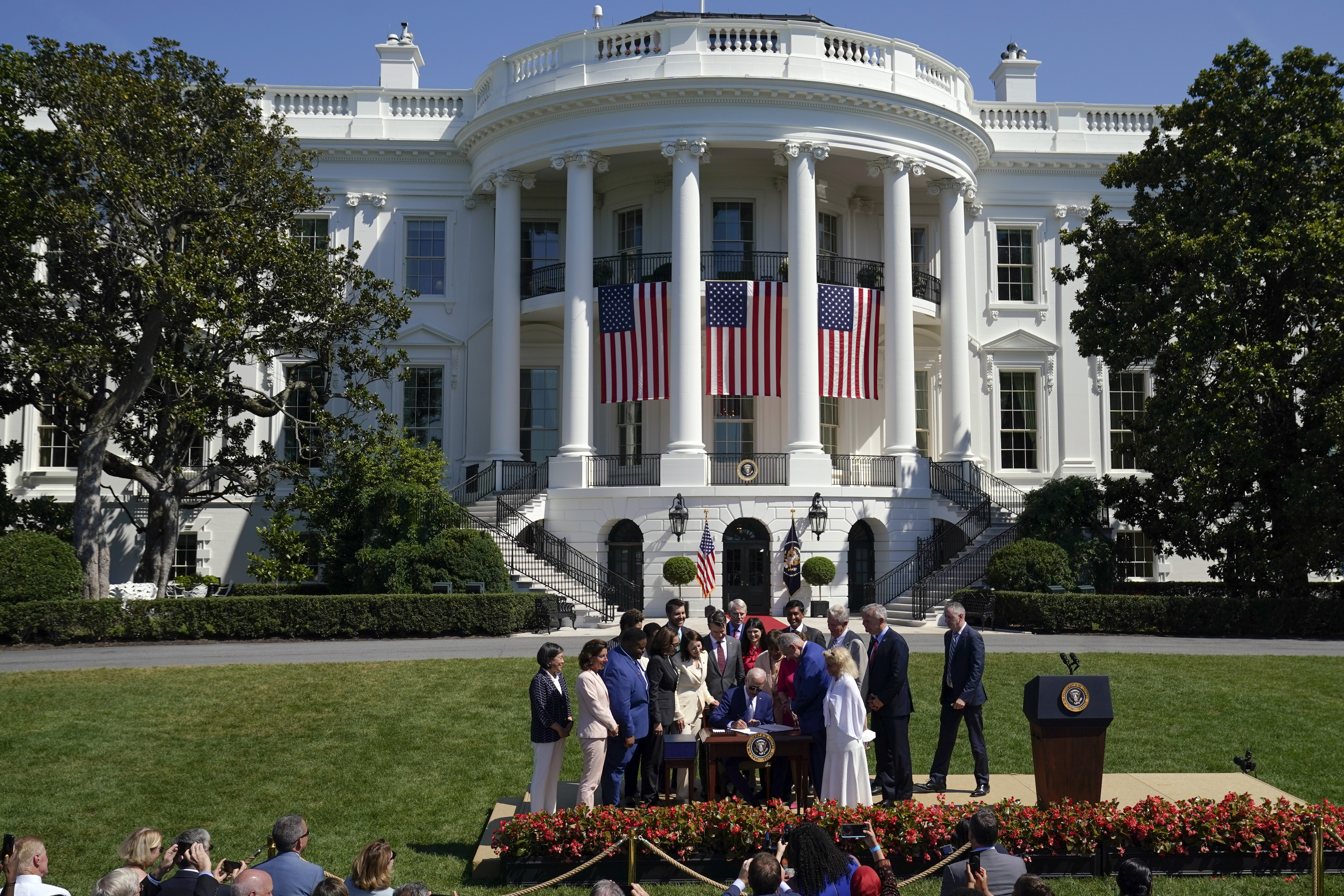 President Joe Biden signs the "CHIPS and Science Act of 2022" during a ceremony on the South Lawn of the White House, Tuesday, in Washington.