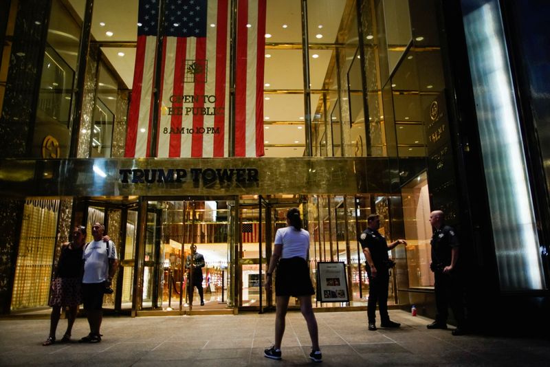 People and police officers stand outside Trump Tower after former U.S. President Donald Trump said that FBI agents raided his Mar-a-Lago Palm Beach home, in New York City, Monday. A House of Representatives committee has the right to see Trump's tax returns, a federal appeals court ruled on Tuesday, rejecting his claims that the request is too political to prevail.