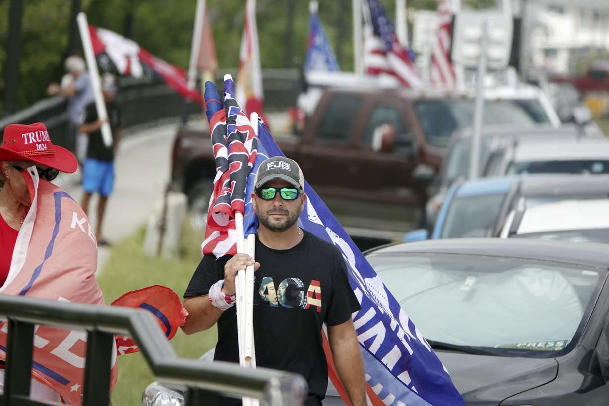 Supporters of former President Donald Trump walk down Southern Boulevard, Tuesday, to protest the FBI raid at Mar-a-Lago in Palm Beach on Monday.
