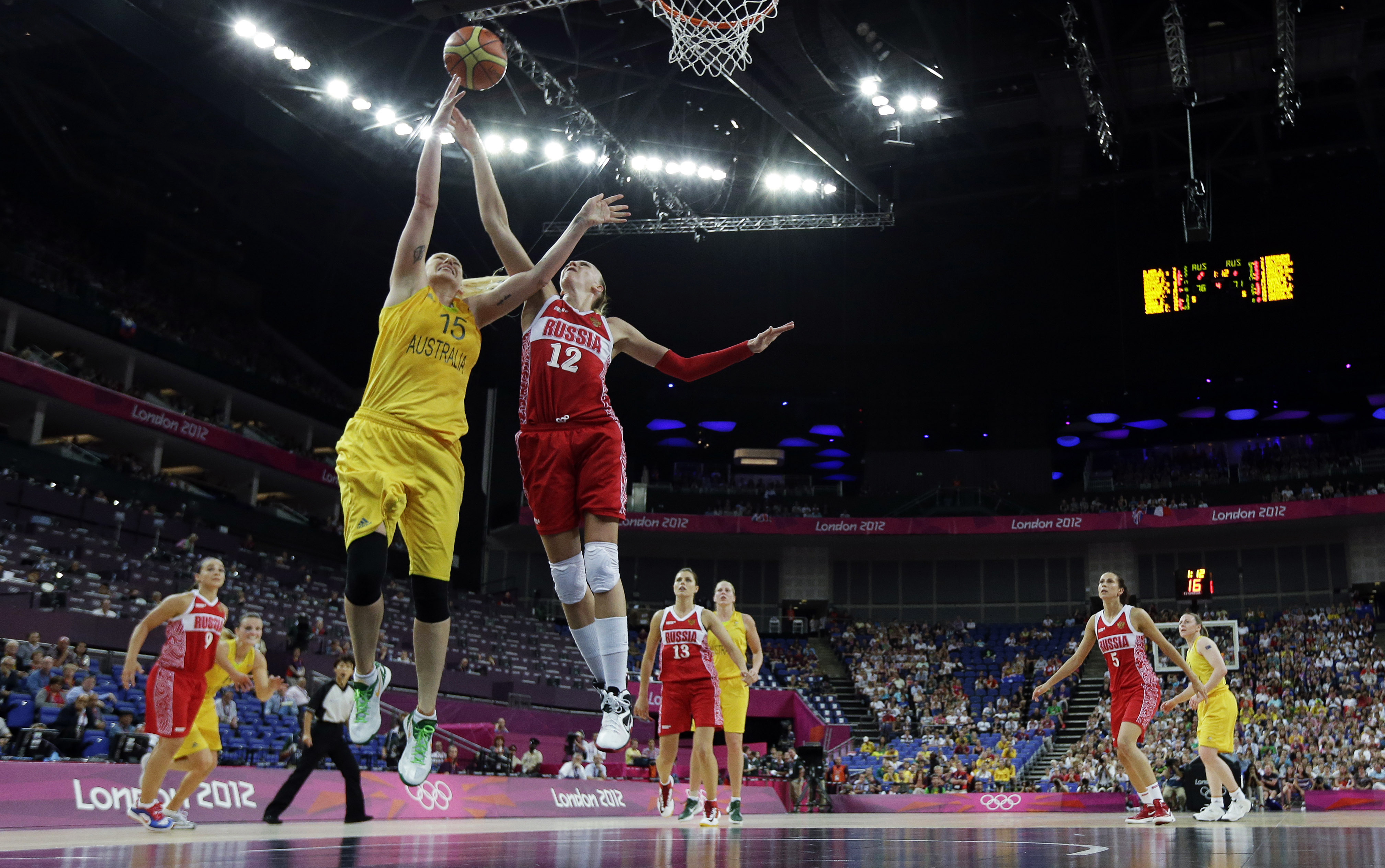 FILE - Australia's Lauren Jackson (15) drives to the basket as Russia's Irina Osipova (12) defends during a women's bronze medal basketball game at the 2012 Summer Olympics, Saturday, Aug. 11, 2012, in London. Jackson is savoring every minute of her basketball comeback, in 2022, even though the battle-tested Australian hoops icon knows she can't do things that once captivated fans before retiring from the sport in 2016. 