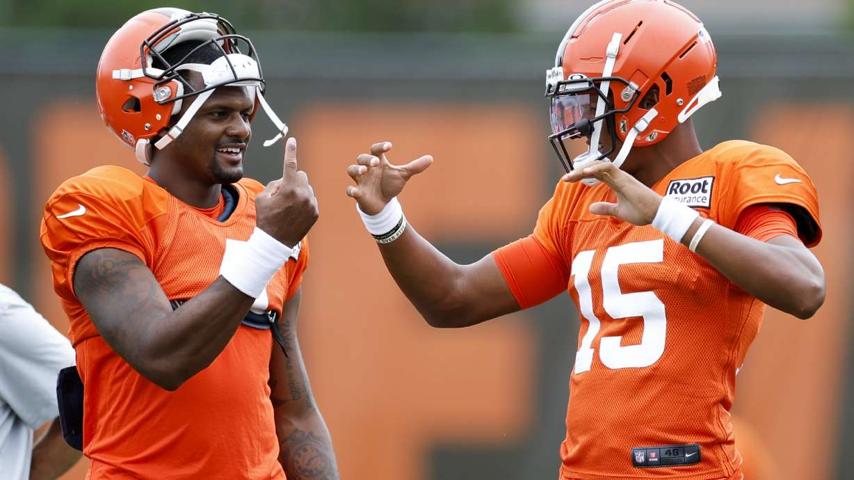 Cleveland Browns quarterback Deshaun Watson, left, talks with quarterback Joshua Dobbs during the NFL football team's training camp, Tuesday, Aug. 9, 2022, in Berea, Ohio.