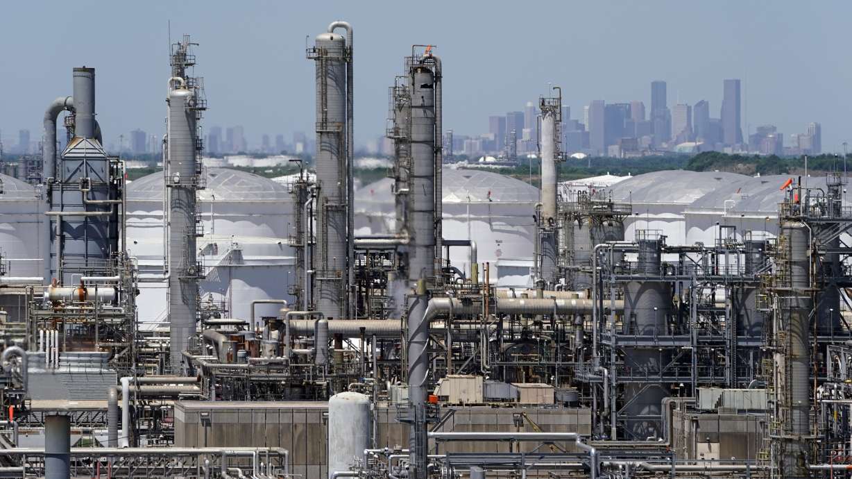 A refinery along the Houston Ship Channel is seen with downtown Houston in the background on April 30, 2020. Billions of dollars in climate and environment investments from the Inflation Reduction Act could flow to communities in the United States that have been plagued by pollution and climate threats for decades.