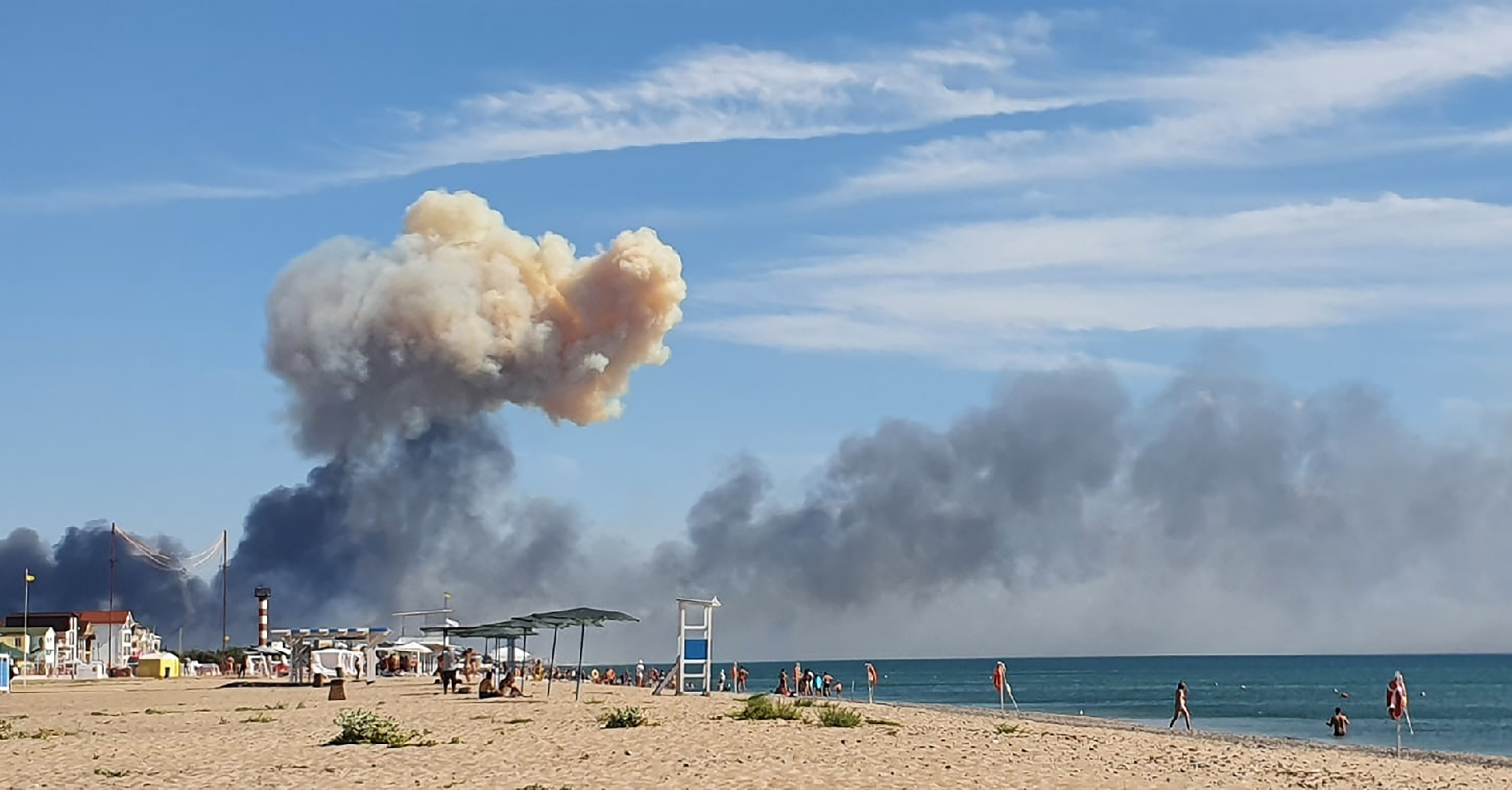 Rising smoke can be seen from the beach at Saky after explosions were heard from the direction of a Russian military airbase near Novofedorivka, Crimea, Tuesday. The explosion of munitions caused a fire at a military air base in Russian-annexed Crimea Tuesday but no casualties or damage to stationed warplanes, Russia's Defense Ministry said.