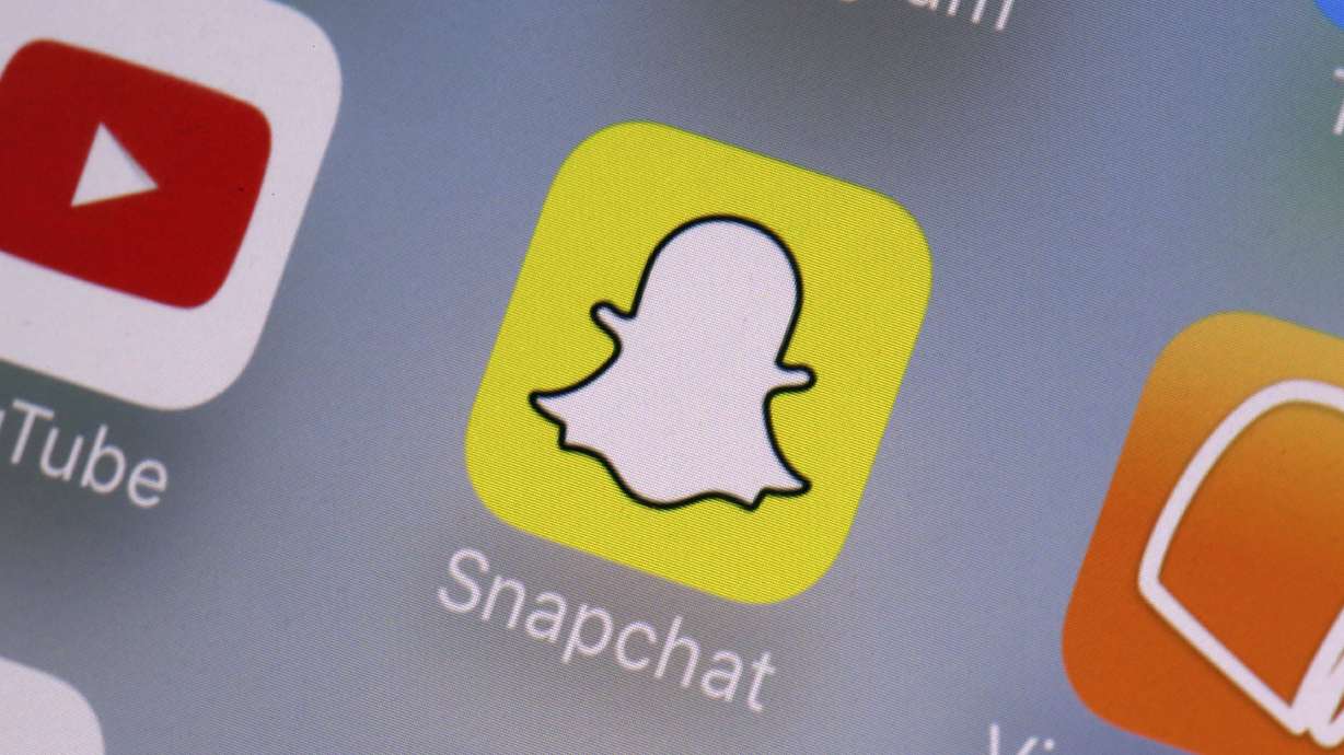 The Snapchat app is seen on a mobile device in New York, Aug. 9, 2017. As concerns about social media's impact on teen psychology continue to rise, platforms from Snapchat to TikTok to Instagram are bolting on new features they say will make their services safer and more age appropriate.