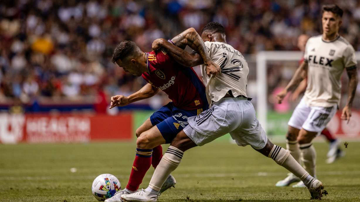 Aaron Herrera, left, wrestles with Diego Palacios of LAFC at Rio Tinto Stadium.