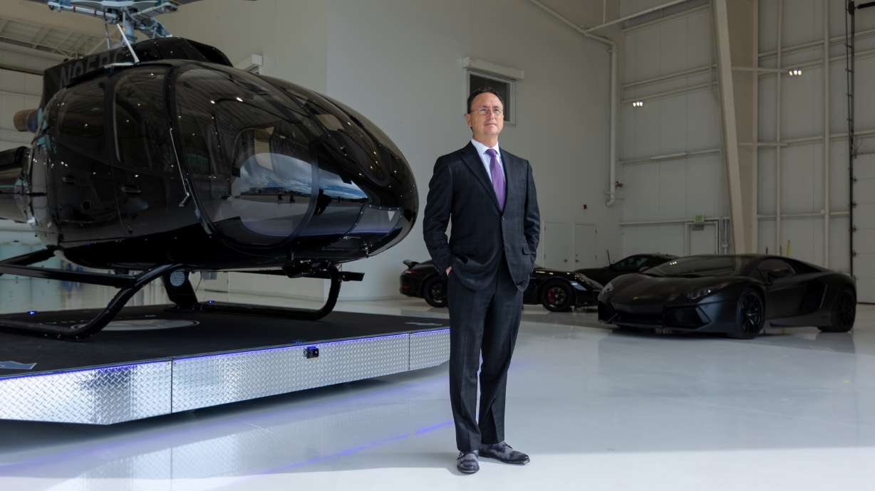 Brandon Fugal stands in his hangar in front of his custom Airbus H130 helicopter in Provo on July 21.