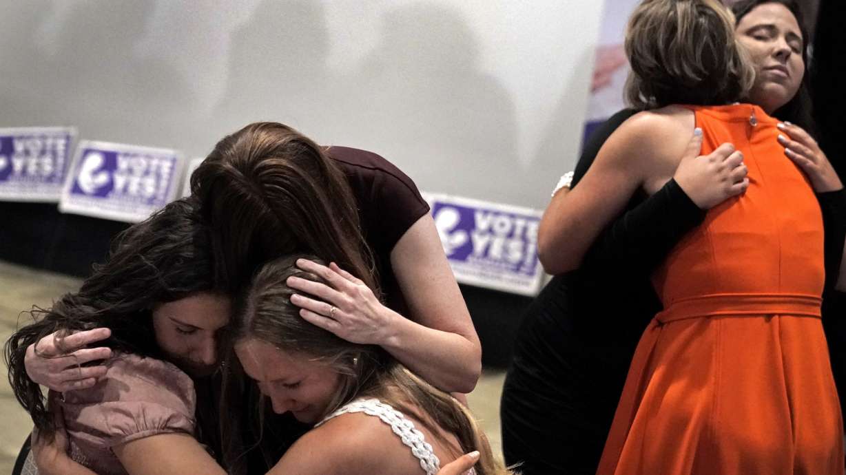 People hug during a “Value Them Both” watch party after a question involving a constitutional amendment removing abortion protections from the Kansas constitution failed on Aug. 2, in Overland Park, Kansas. Abortion rights opponents were shocked and abortion advocates energized by a decisive statewide vote in heavily Republican Kansas this week in favor of protecting abortion access.