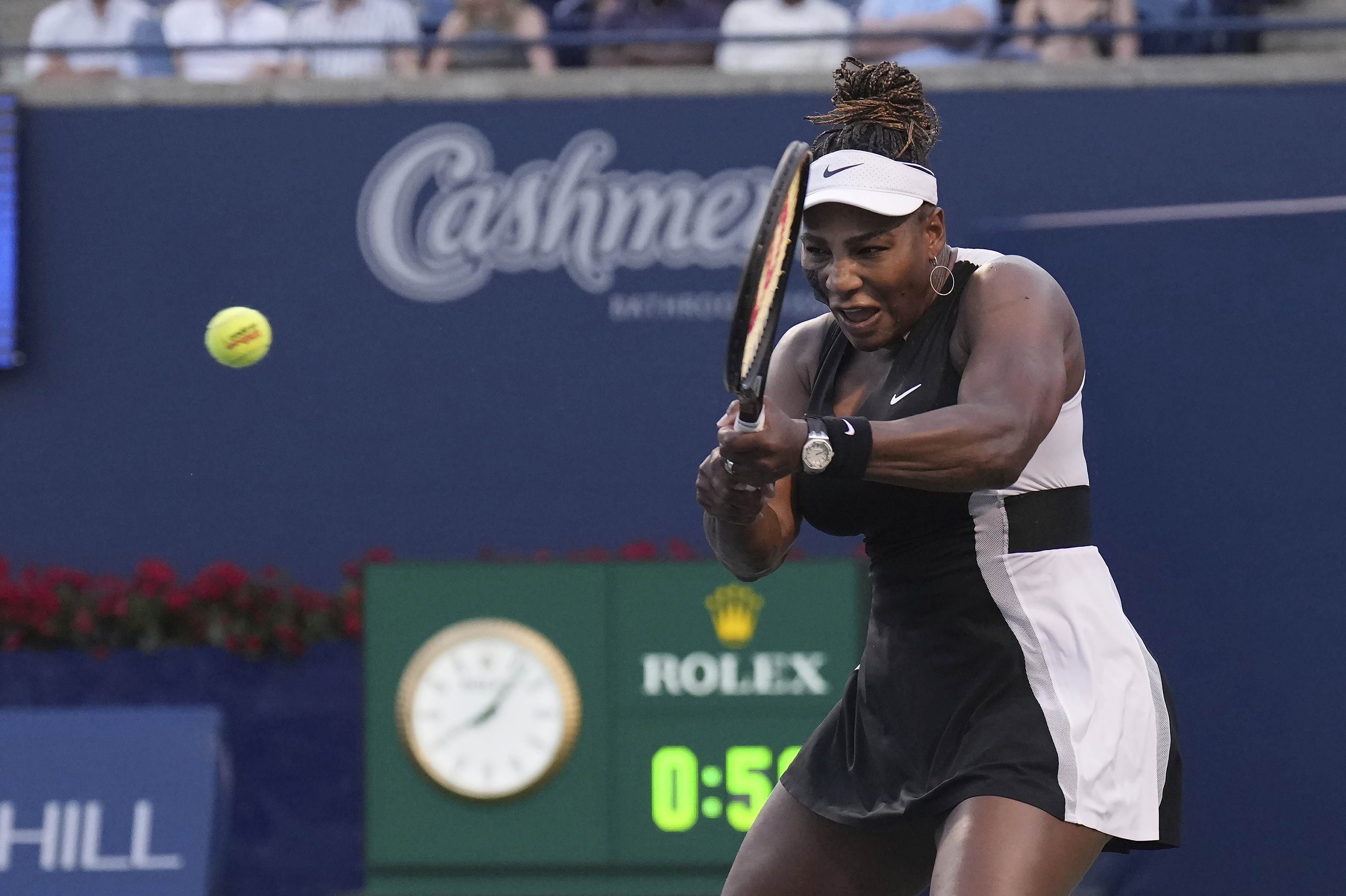 Serena Williams, of the United States, his a backhand to Belinda Bencic, of Switzerland, during the National Bank Open tennis tournament Wednesday, Aug. 10, 2022, in Toronto. 