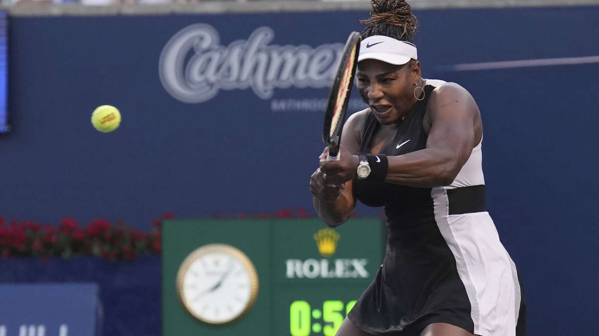 Serena Williams, of the United States, his a backhand to Belinda Bencic, of Switzerland, during the National Bank Open tennis tournament Wednesday, Aug. 10, 2022, in Toronto.