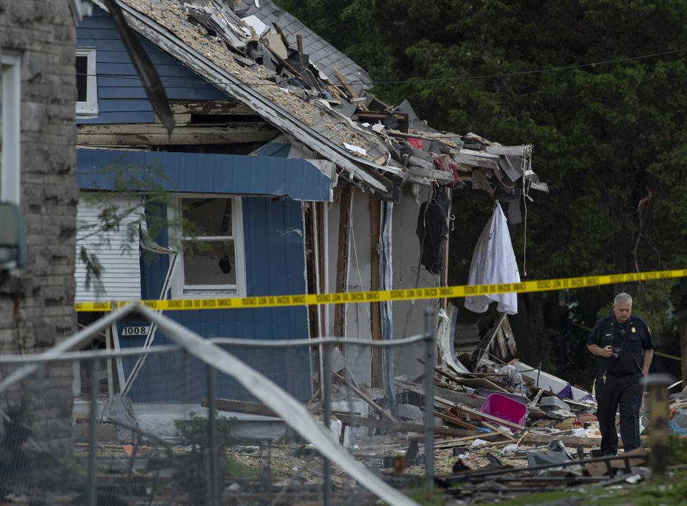 Evansville Fire Department personnel examine the scene after a house explosion in Evansville, Ind., Wednesday. Authorities say a house explosion reverberated across a neighborhood in the southern Indiana city of Evansville killing three people and damaging about 39 homes.