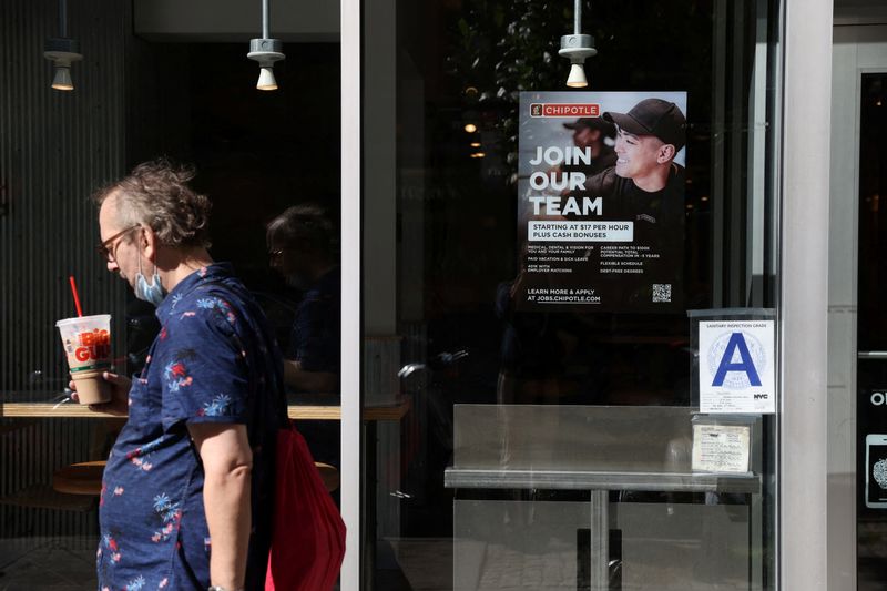 A hiring sign is seen in a restaurant in Manhattan, New York, Friday. The Labor Department said Thursday the number of Americans filing new claims for unemployment benefits rose for the second straight week.