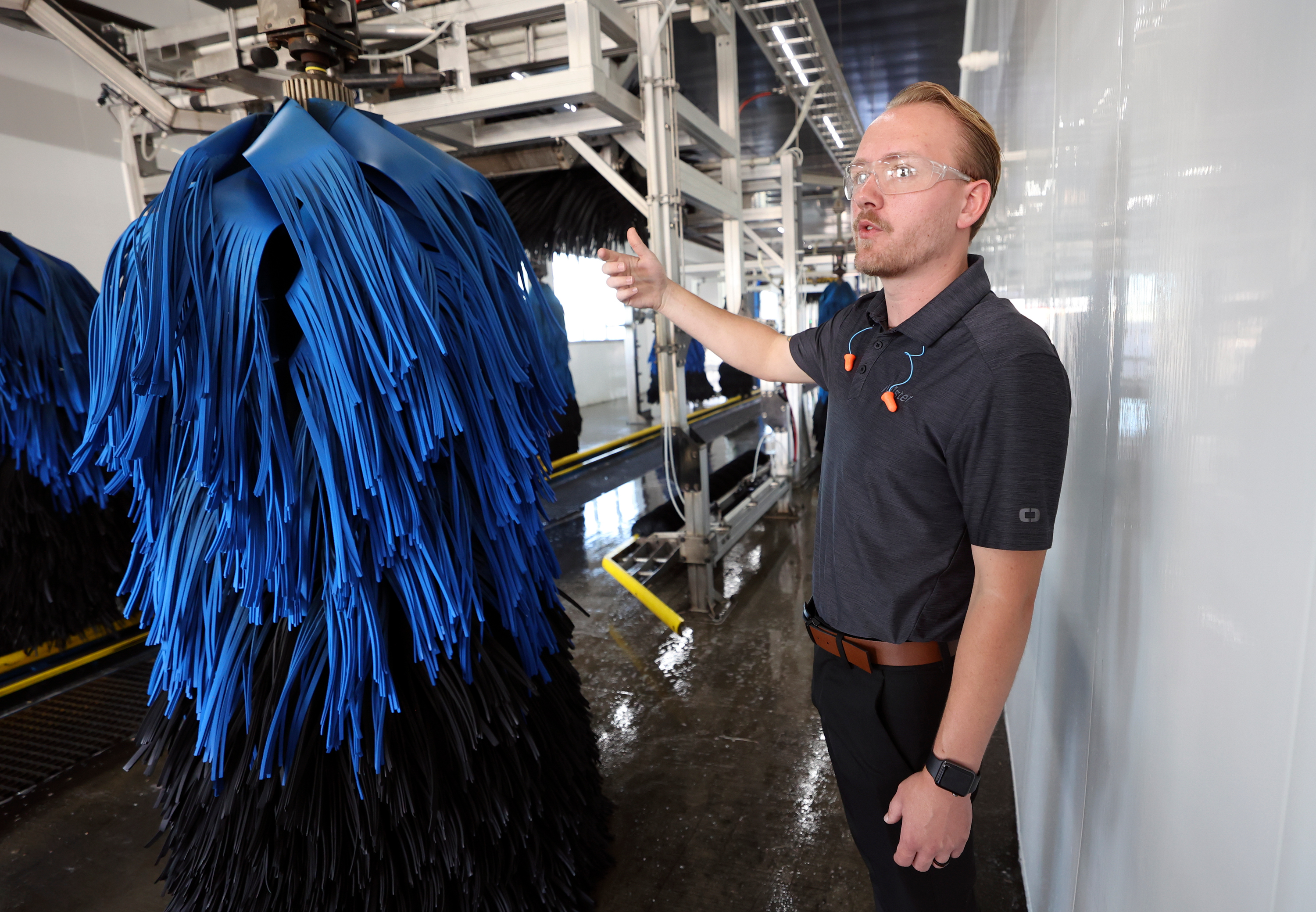 Robert Bartholomew, regional manager of Mister Car Wash Utah, talks about getting wrap brushes wet enough to optimize contact with vehicles moving through Mister Car Wash in West Jordan on Tuesday. The car wash company says it has reduced its water use by 30%.
