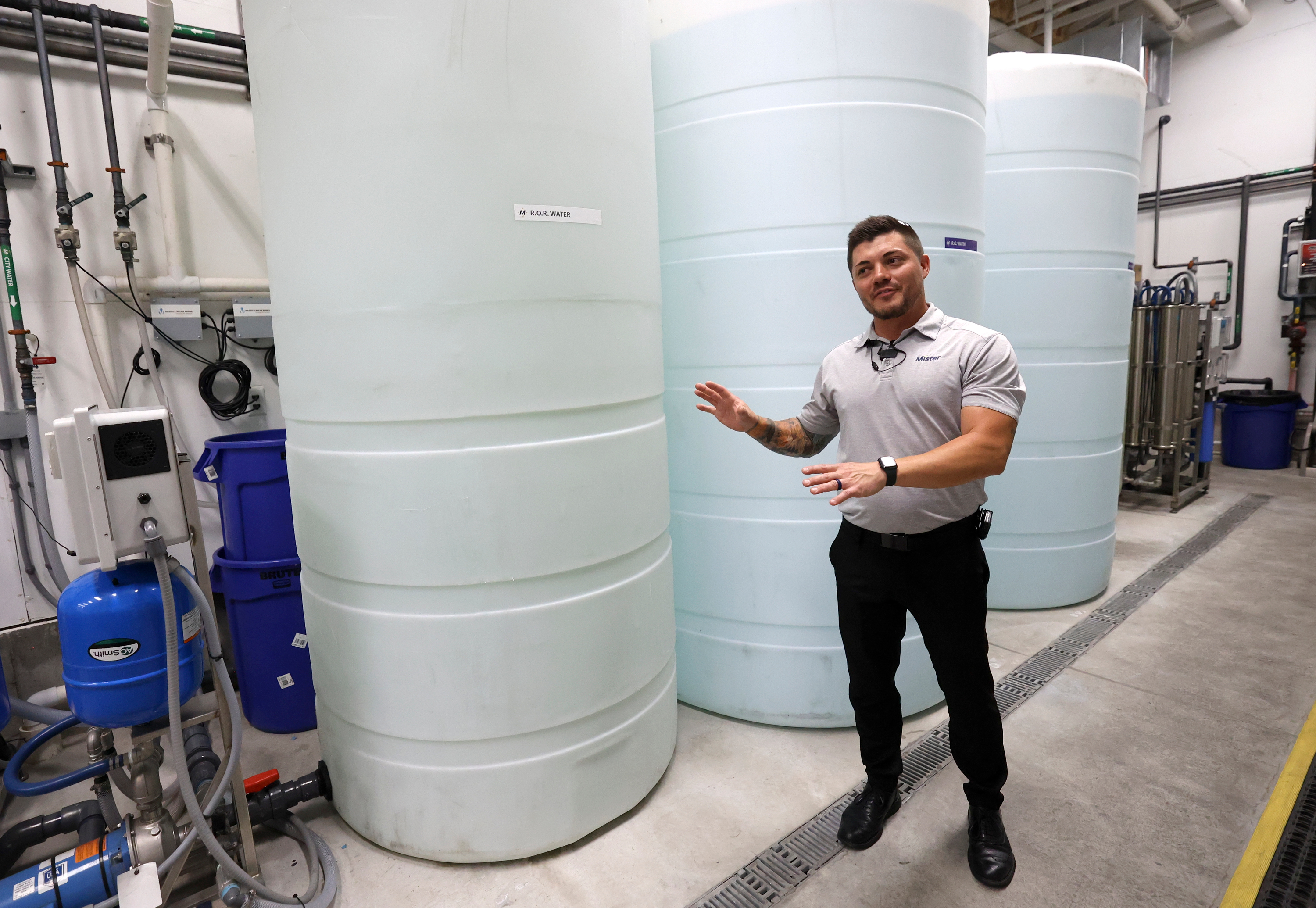 Landon Williams, general manager of Mister Car Wash Highlands West Jordan, talks about reverse osmosis water filtration, water reclamation and water optimization on Tuesday. The company says it has reduced its water use by 30%.