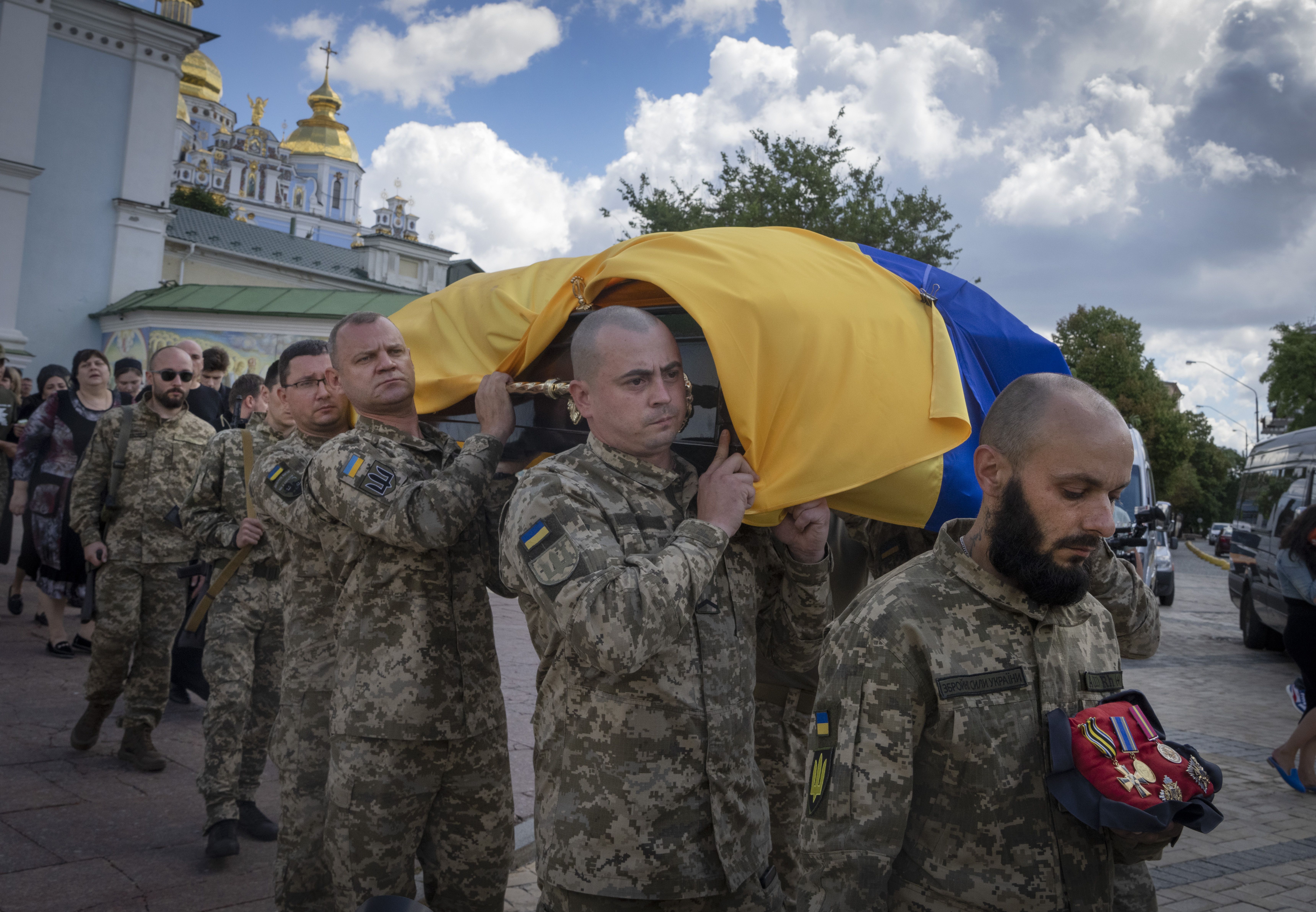 Ukrainian soldiers carry the casket of a soldier, codename Fanat, killed by the Russian troops in a battle, during his funeral at St Michael cathedral in Kyiv, Ukraine, on July 18.