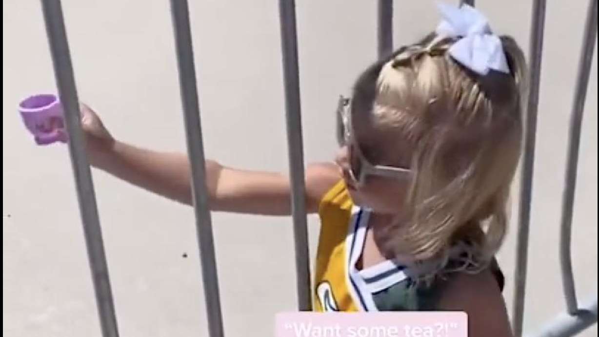 Screenshot of video of Aria Rubens offering tea to Green Bay players.