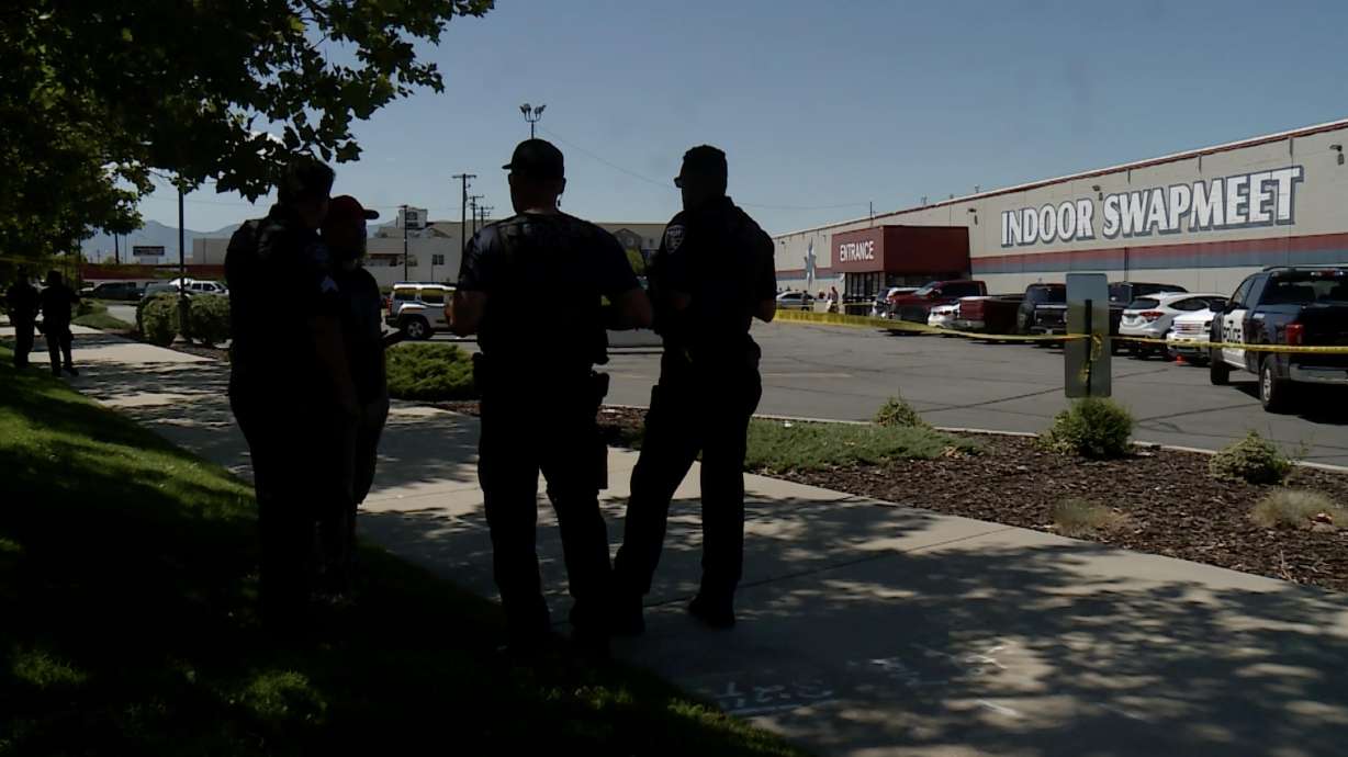 Police investigate after a man was shot and injured by police officers near an indoor swap meet in West Valley City on Sunday, Aug. 7, 2022.