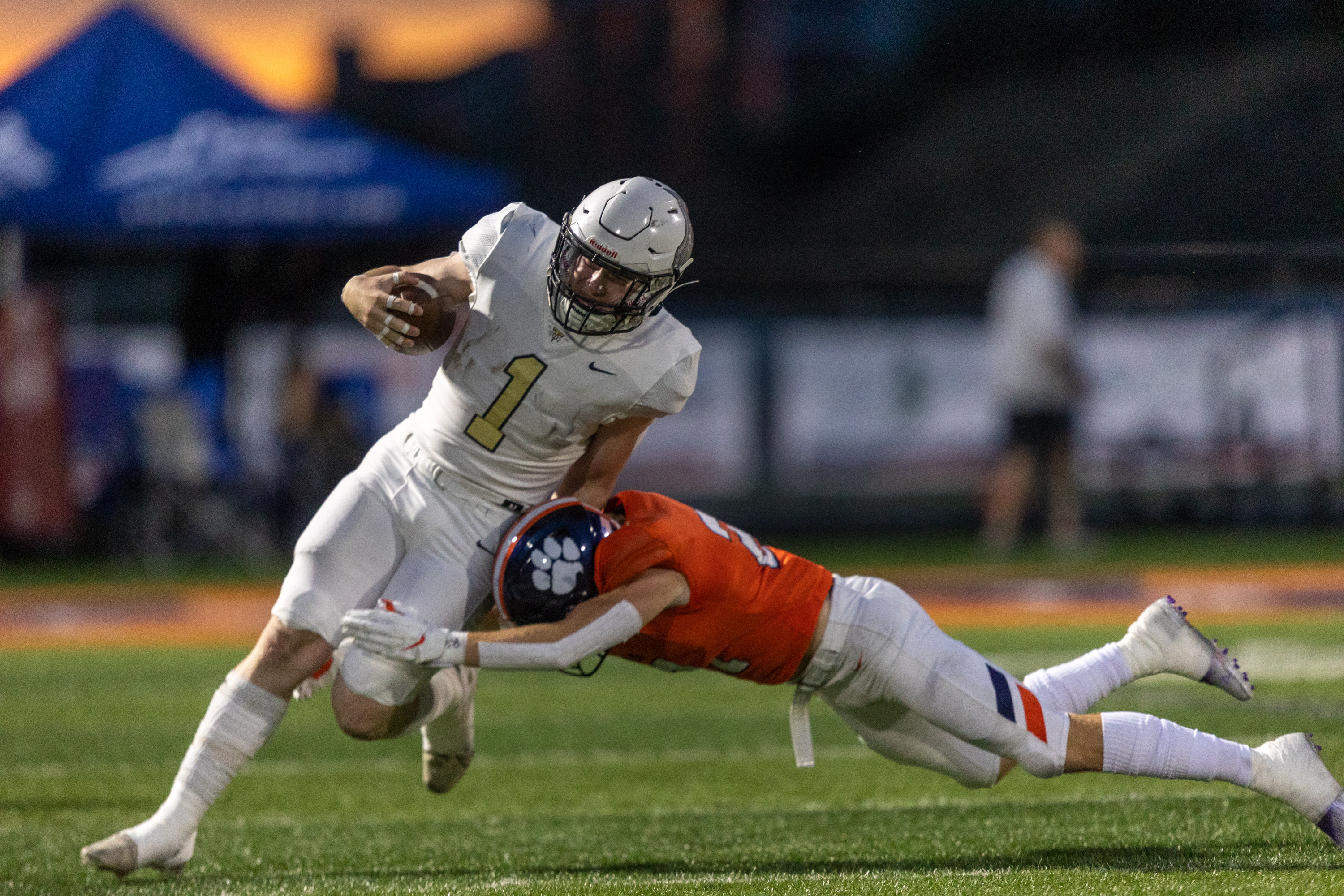 Tyden Morris (1) of Deseret Hills is tackled by Jace Matheson (21) of the Brighton Bengals in Cottonwood Heights on Thursday, Aug. 11, 2022.