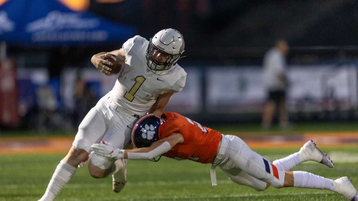 Tyden Morris (1) of Deseret Hills is tackled by Jace Matheson (21) of the Brighton Bengals in Cottonwood Heights on Thursday, Aug. 11, 2022.