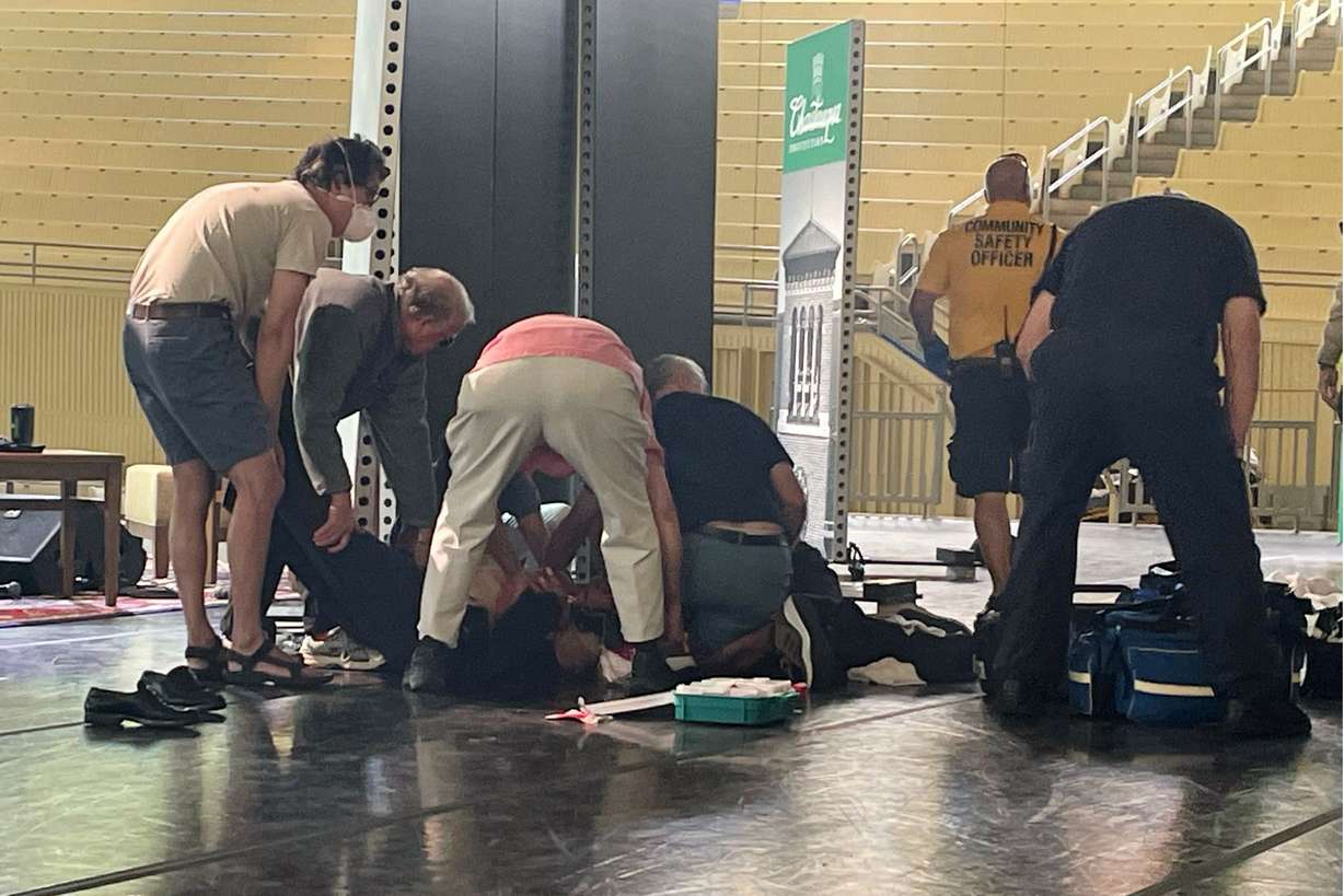 Author Salman Rushdie is tended to after he was attacked during a lecture, Friday at the Chautauqua Institution in Chautauqua, N.Y., about 75 miles south of Buffalo.