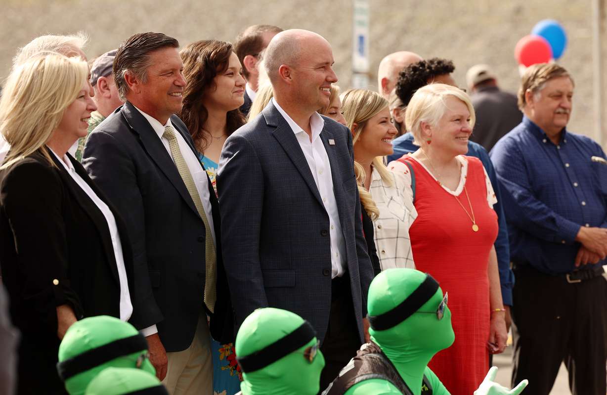 Gov.Spencer J. Cox, third from left, poses for photos with others during the opening of a new FrontRunner station in Vineyard on Friday.