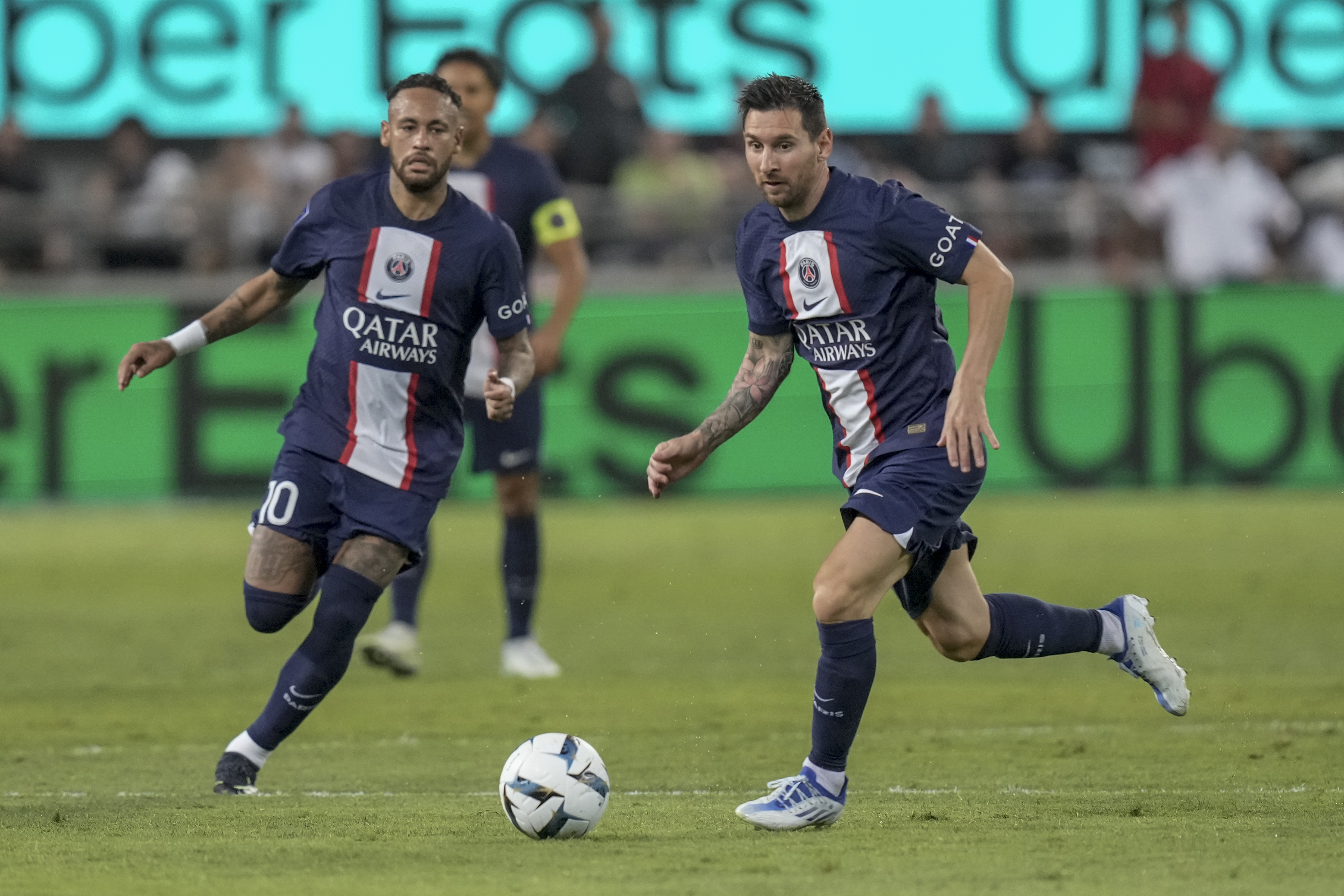 PSG's Lionel Messi, right, controls the ball as PSG's Neymar runs during the French Super Cup final soccer match between Nantes and Paris Saint-Germain at Bloomfield Stadium in Tel Aviv, Israel, Sunday, July 31, 2022. 
