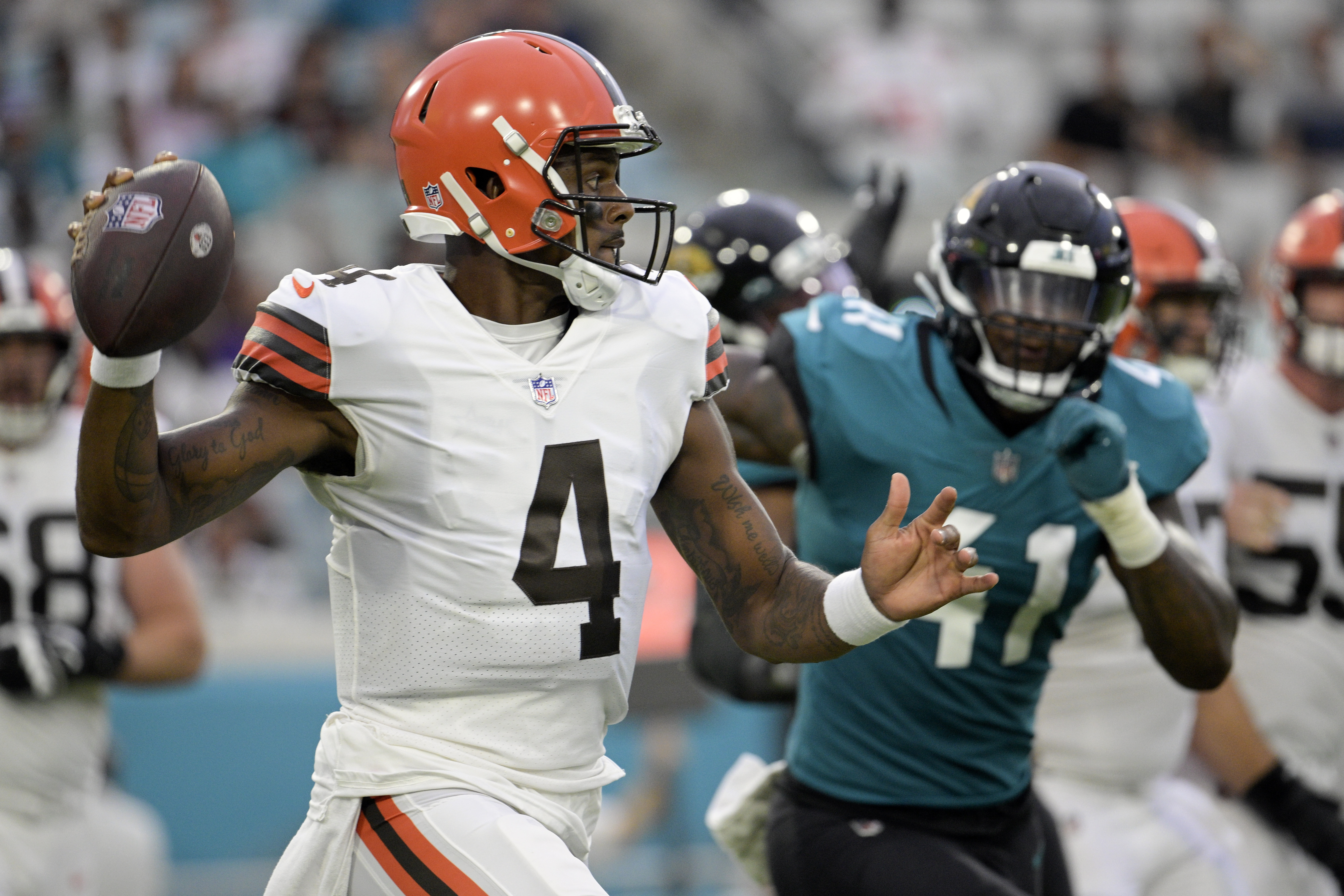 Cleveland Browns quarterback Deshaun Watson (4) looks for a receiver as he is pressured by Jacksonville Jaguars linebacker Josh Allen (41) during the first half of an NFL preseason football game, Friday, Aug. 12, 2022, in Jacksonville, Fla. 
