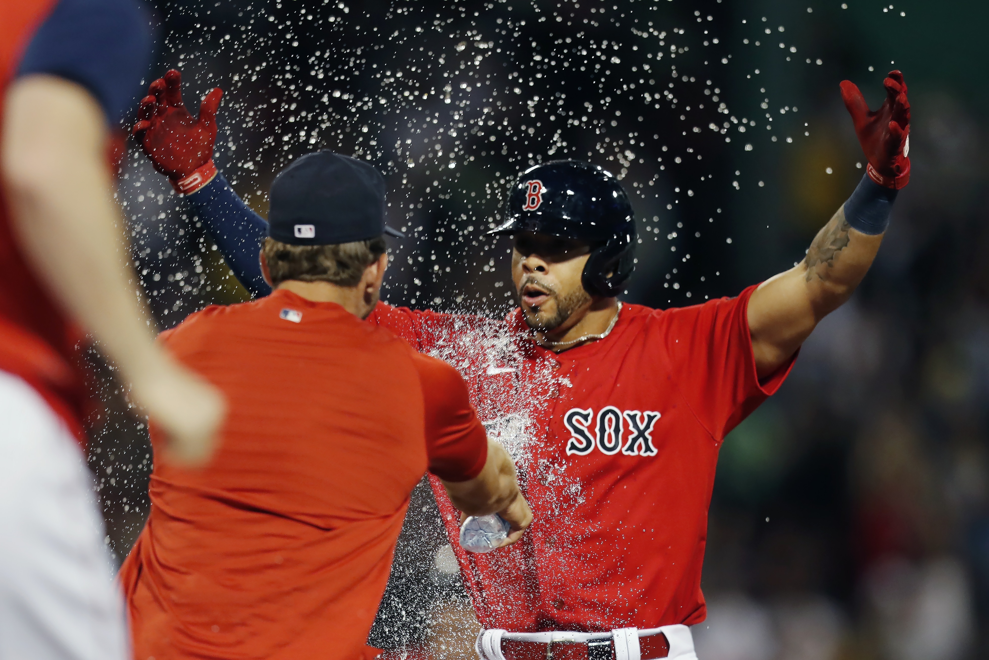 Boston Red Sox's Tommy Pham, right, celebrates after hitting a walkoff RBI-single during the 10th inning of a baseball game against the New York Yankees, Friday, Aug. 12, 2022, in Boston. 