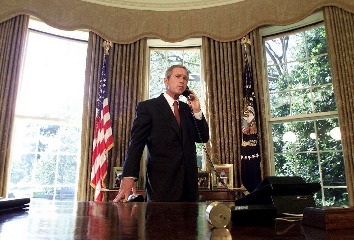 President George W. Bush speaks by telephone from the Oval Office at the White House in Washington with New York City Mayor Rudy Giuliani and New York Gov. George Pataki, Sept. 13, 2001. Bush's national emergency three days after the Sept. 11 attacks still stands.