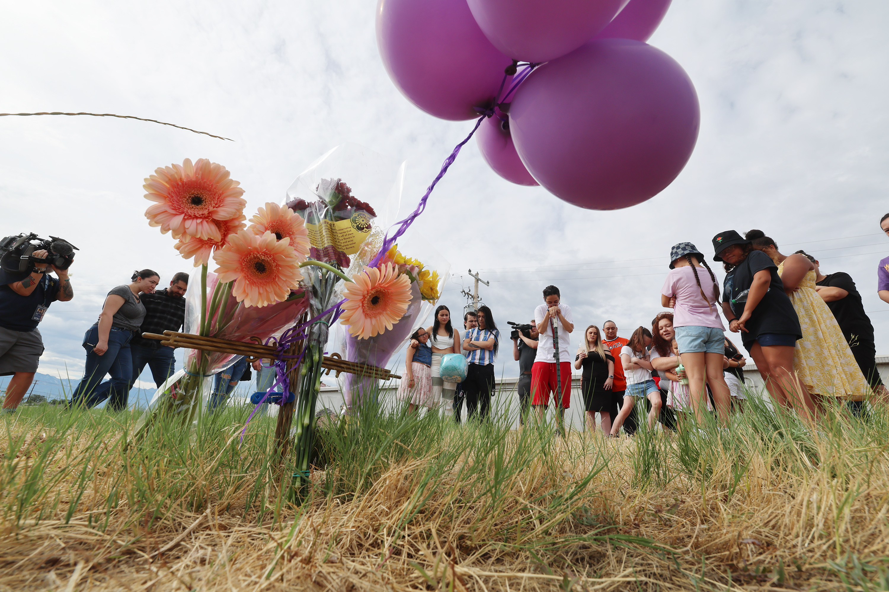 Family members stand near a small marker that they placed after private investigator Jason K. Jensen, announced an increase in the reward for information in the murder case of Rosie Tapia on Saturday. The reward is now $100,000. The family came out to the place Rosie’s body was found 27 years ago along the Jordan River and California Avenue in Salt Lake City.